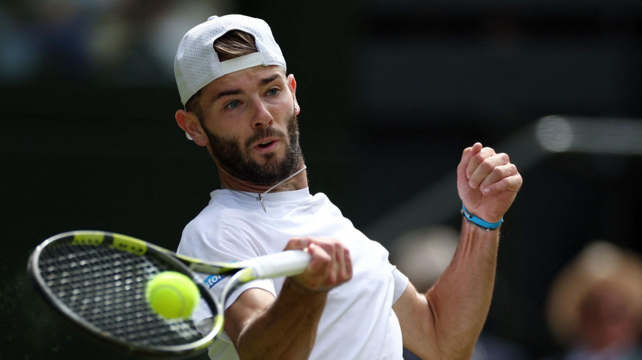 Jacob Fearnley hits a forehand return in his Wimbledon match against Novak Djokovic in July 2024