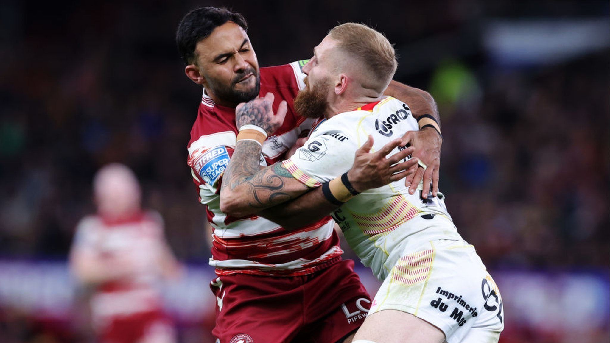 Sam Tomkins is tackled by Bevan French