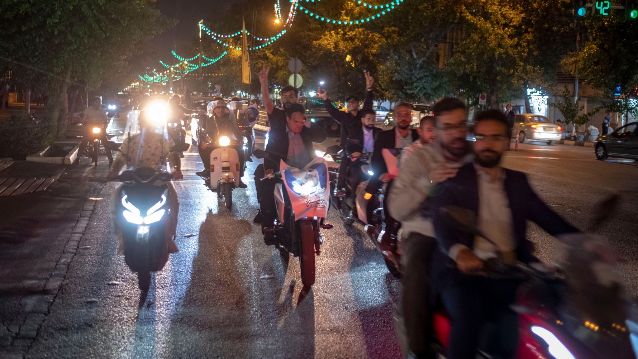 Supporters of Iranian presidential candidate Mohammad Baqer Qalibaf ride motorbikes on Tehran's Revolution Avenue