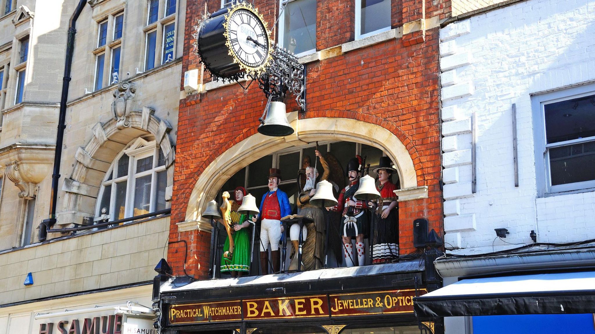 Bakers Jewellers with statues and a clock above along Southgate Street, Gloucester