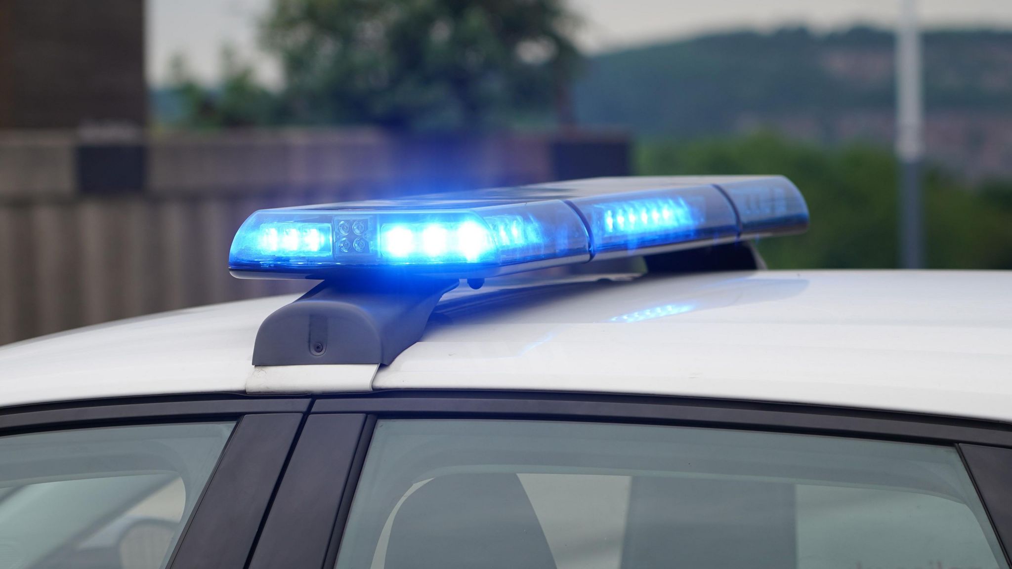 A stock image of blue lights on a police car