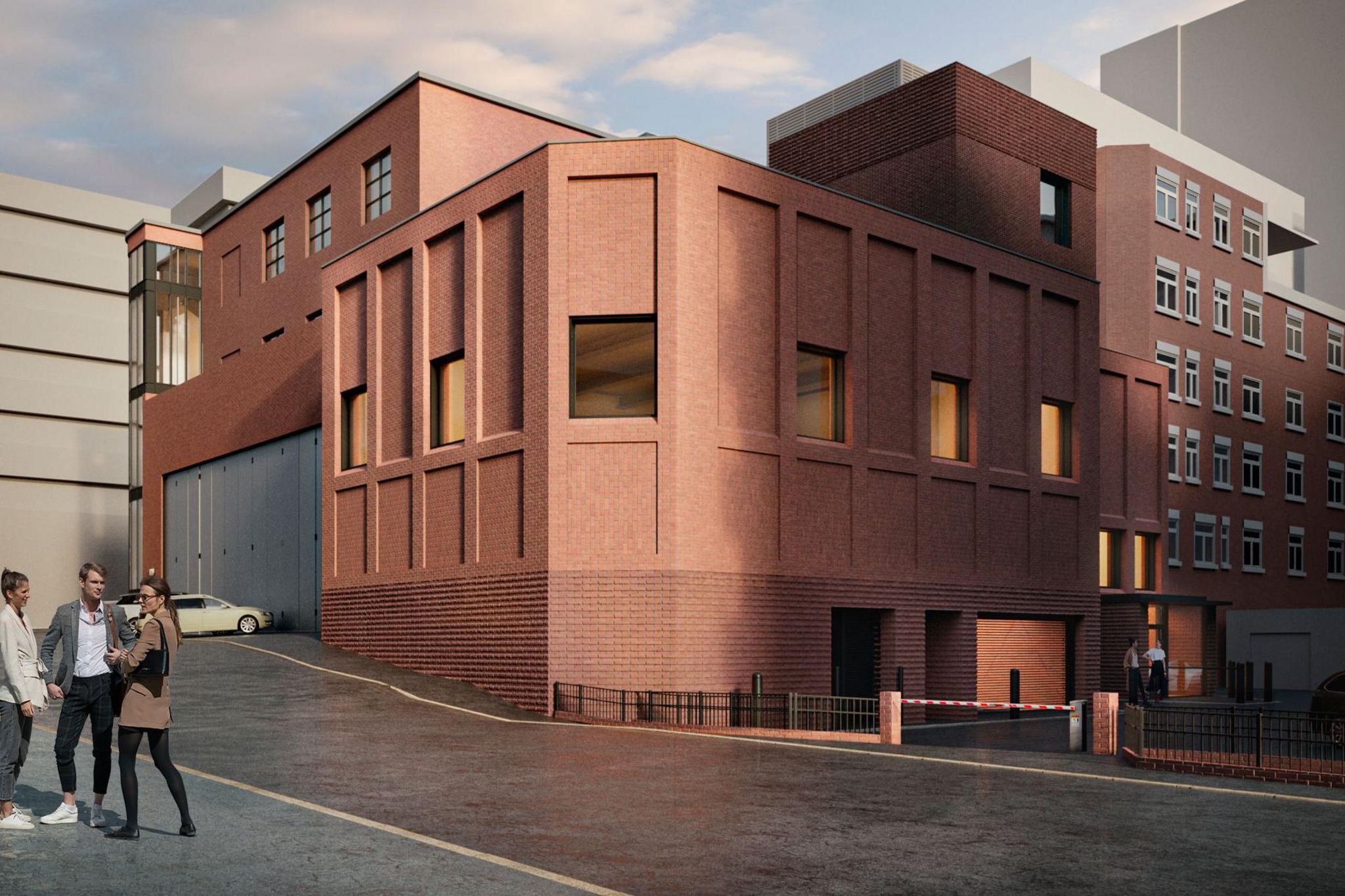 Artist impression Of Mayflower Theatre's proposed rehearsal studio development. It is a large red brick modern building. A garage door is visible, possibly for transporting goods to the building.