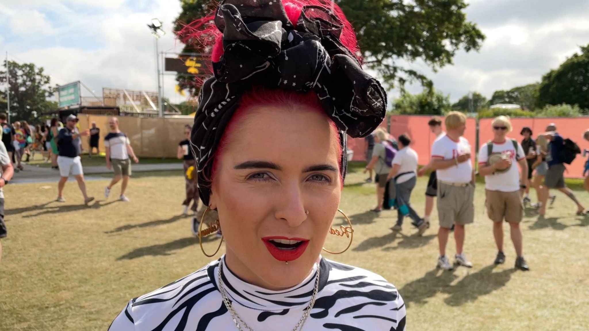 Hatice Tuzun, an artist who creates political music, with pink hair and large earnings at the Isle of Wight Festival at the 