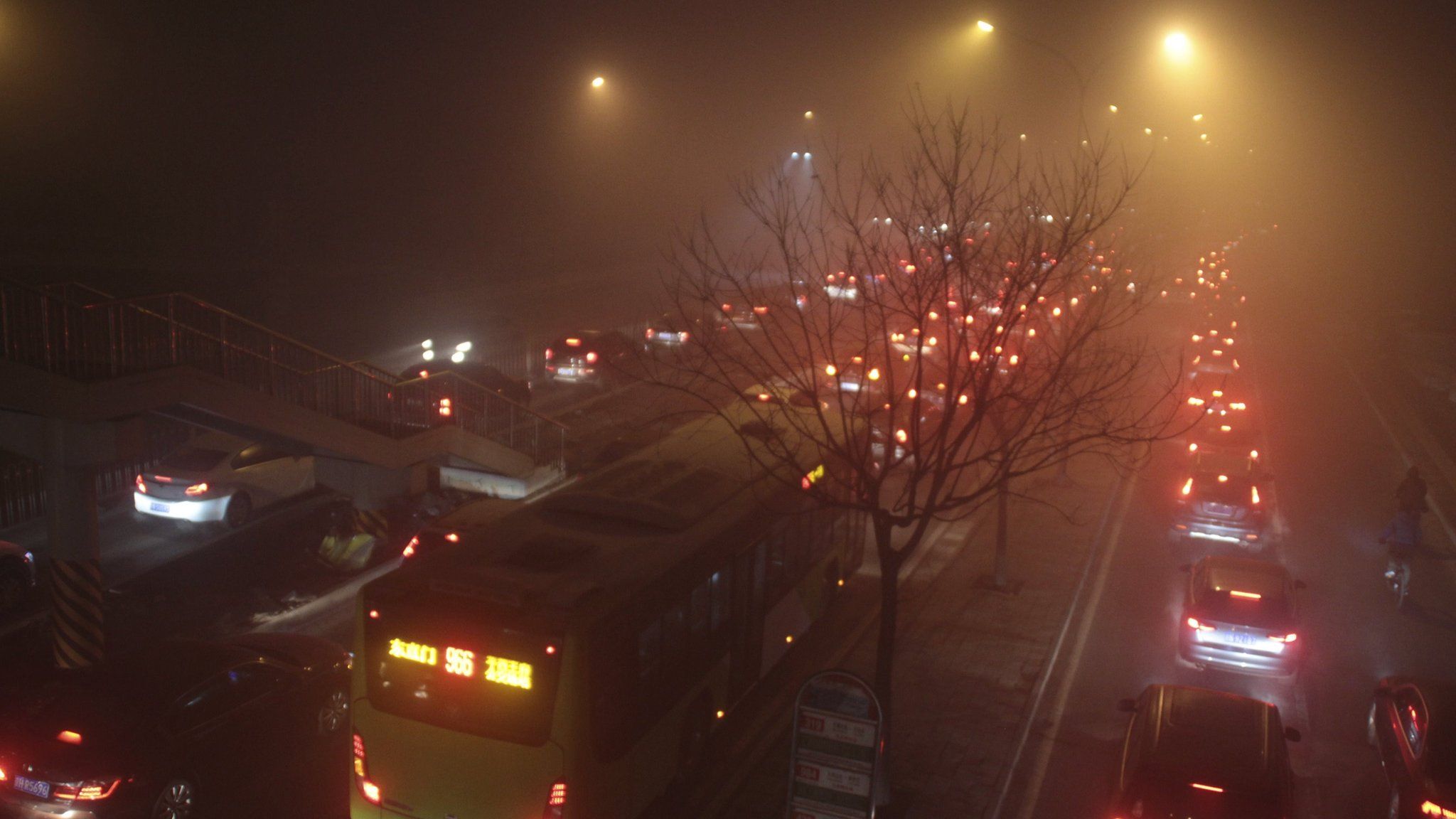 A traffic jam in thick smog, at night