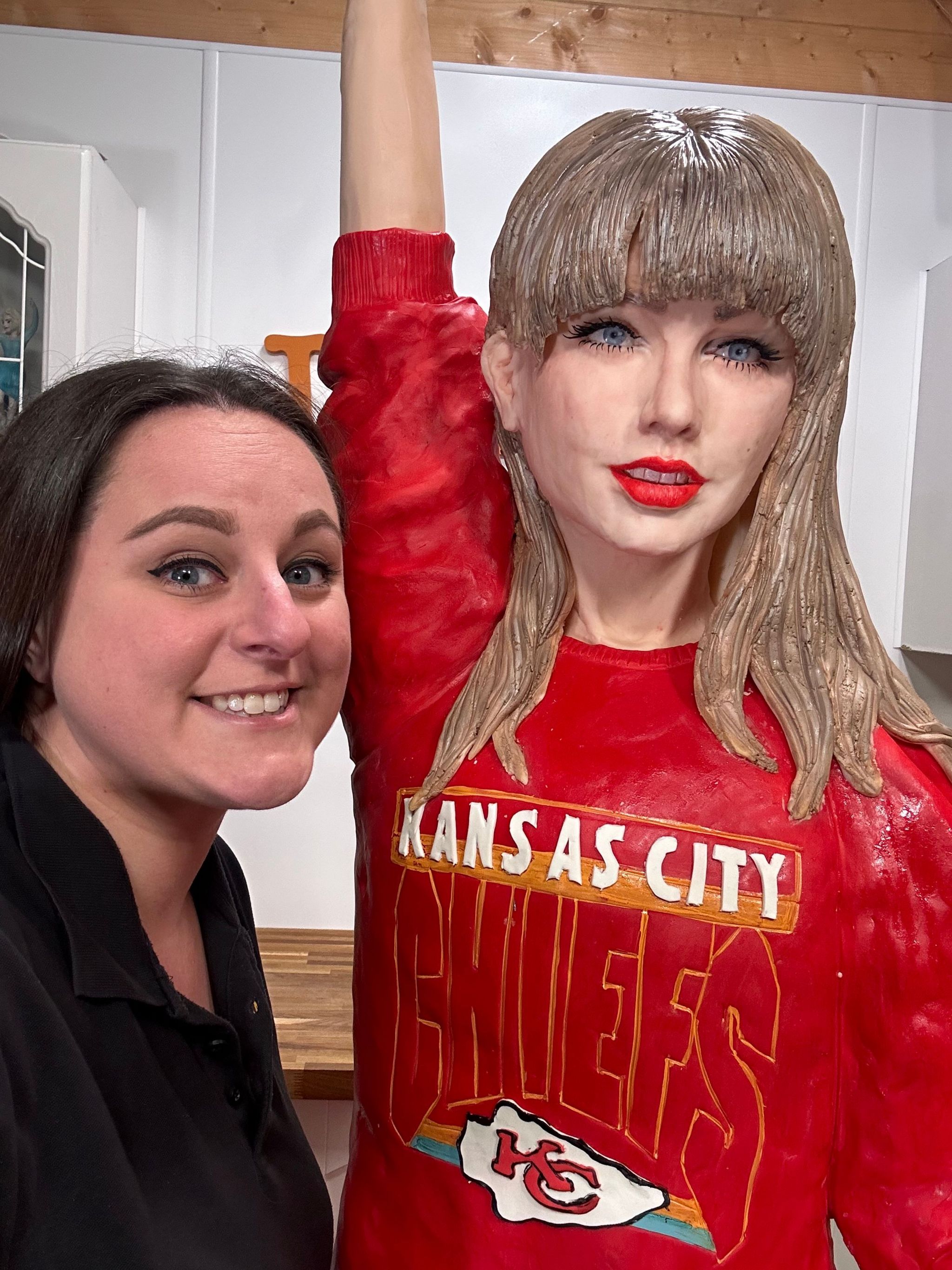 Lara Mason smiling next to her Taylor Swift creation