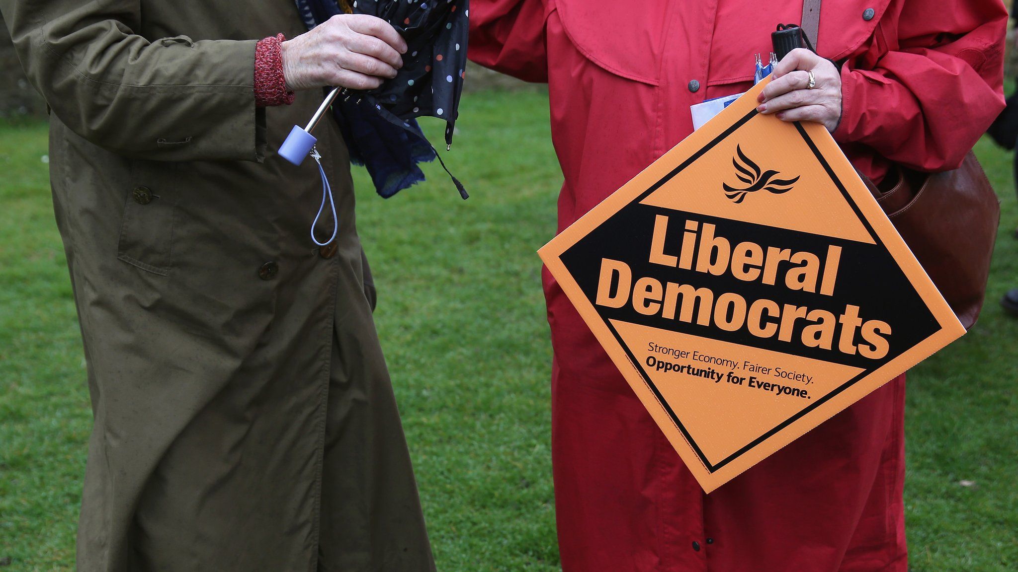 Liberal Democrat placard and supporters