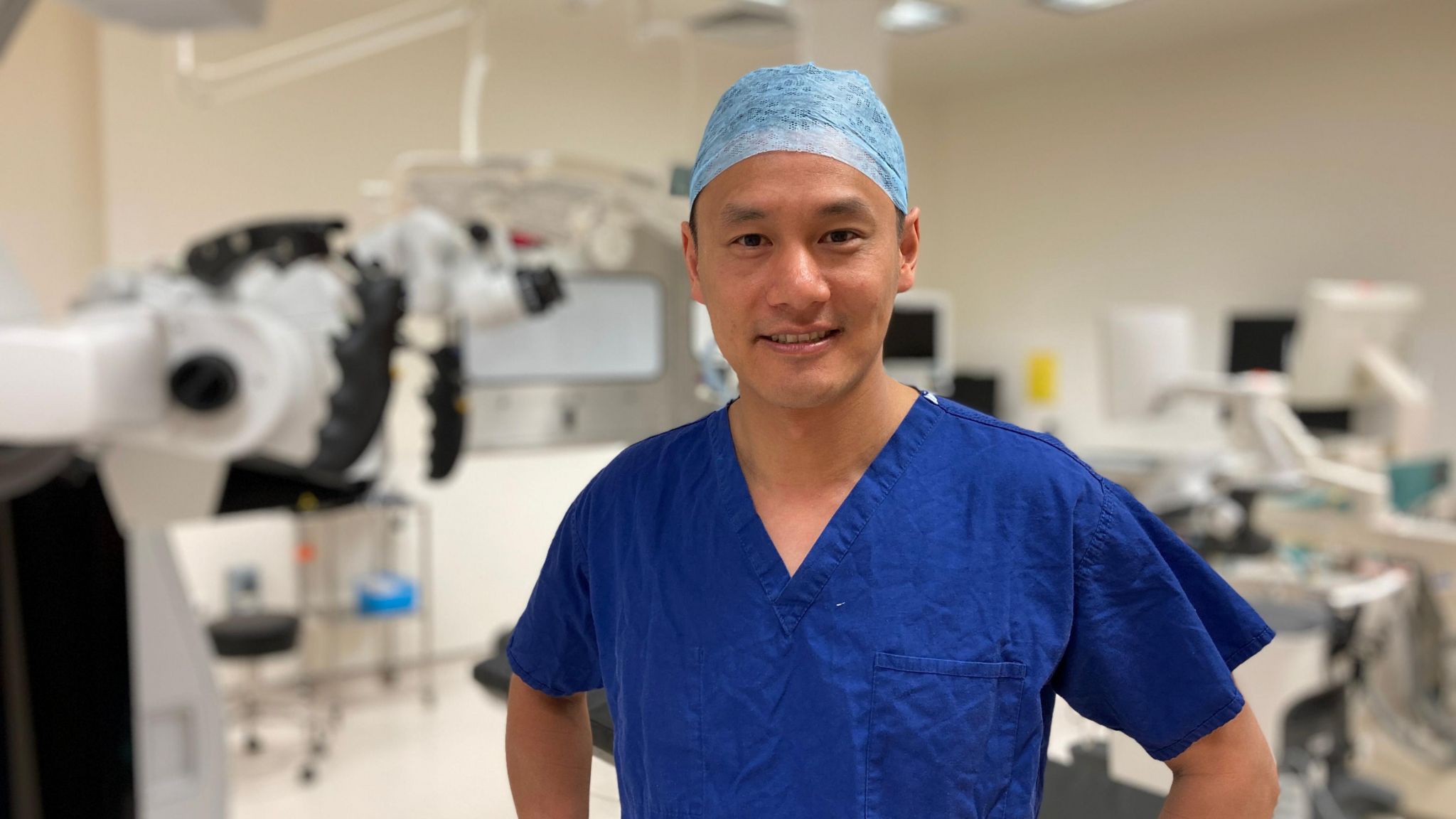 James Chan wearing scrubs in an operating theatre