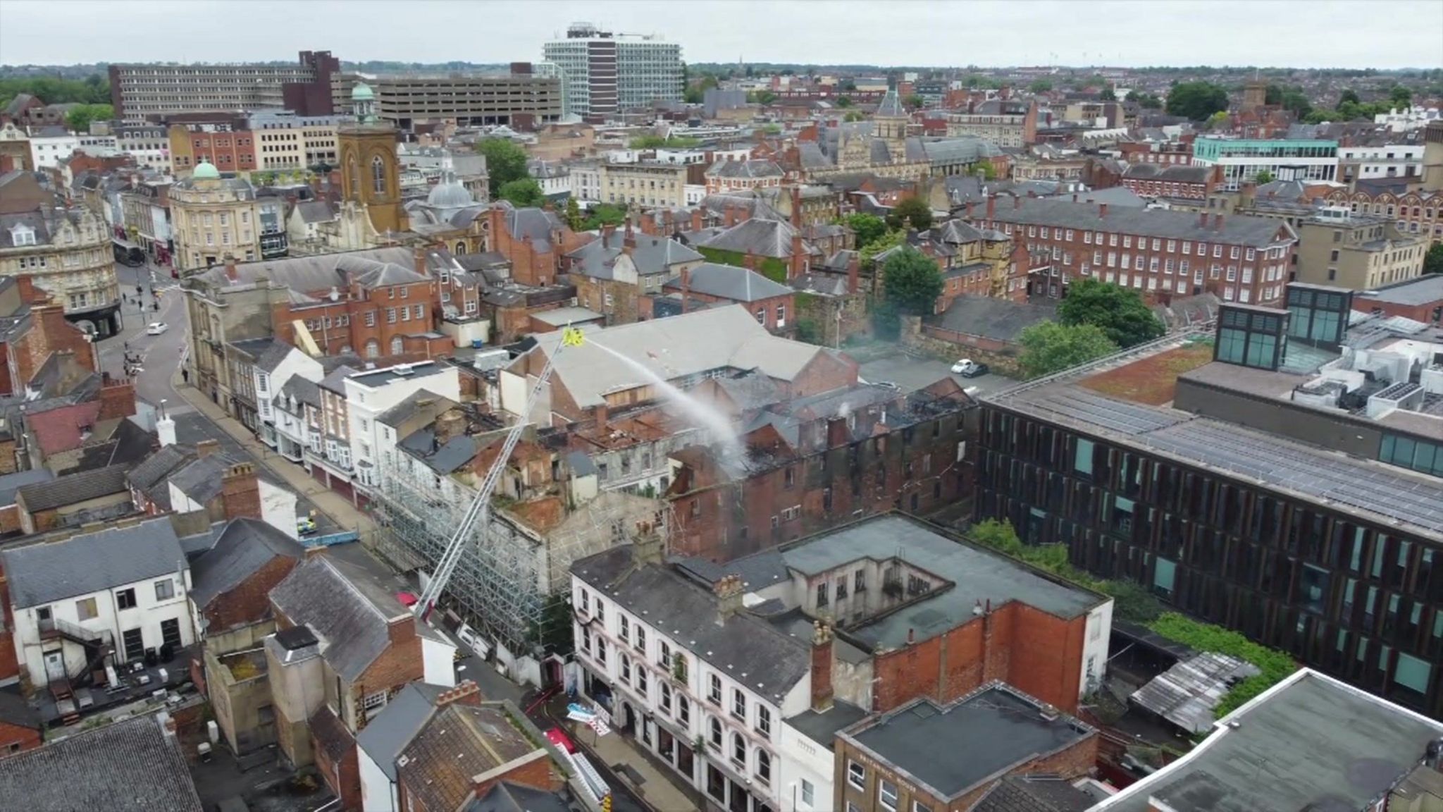 Aerial view of water being poured over a building