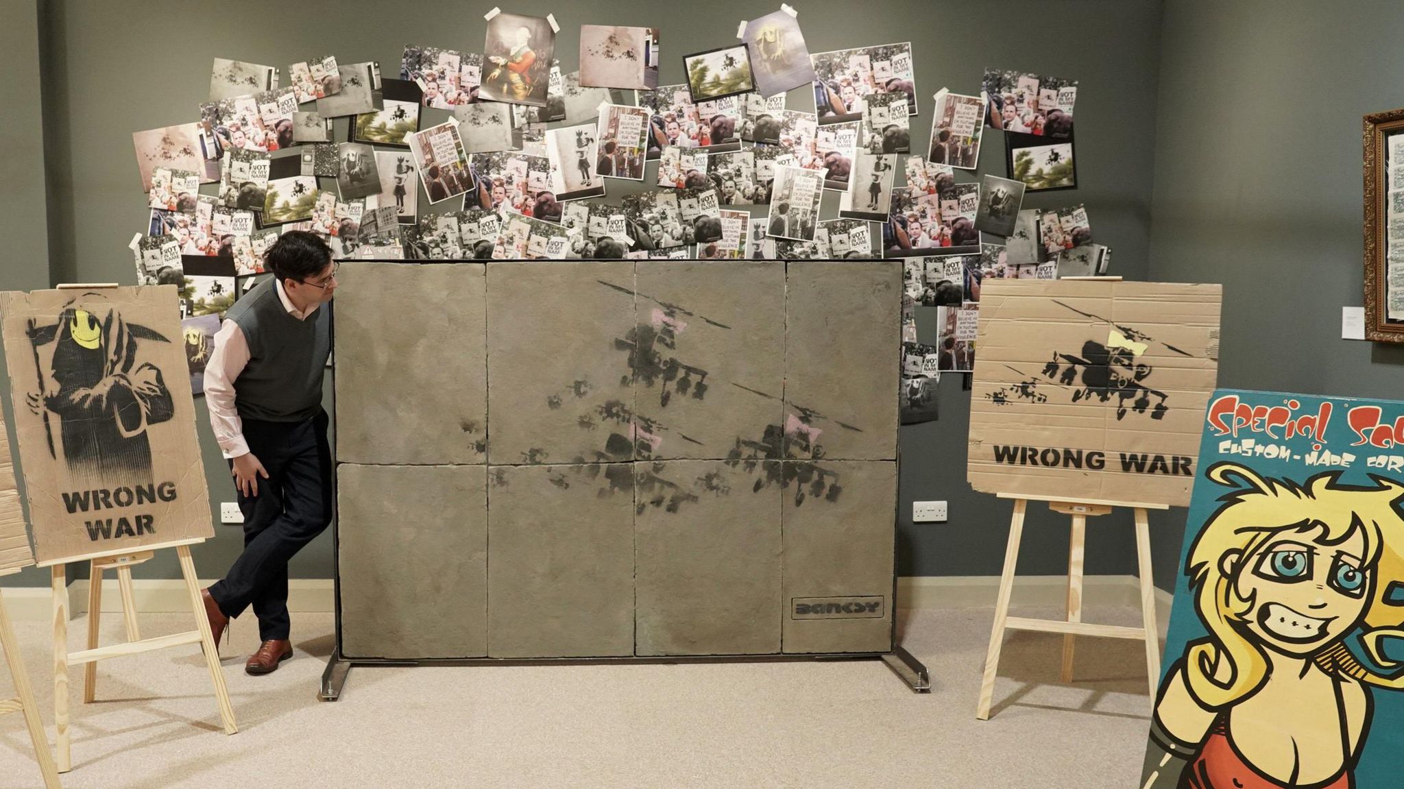 Anderson & Garland director Fred Wyrley-Birch with the Banksy works