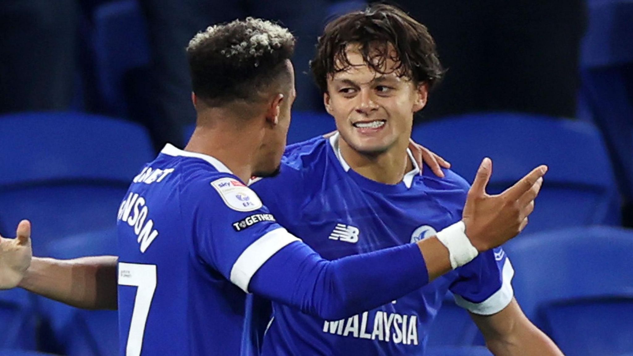 Perry Ng (right) celebrates scoring for Cardiff