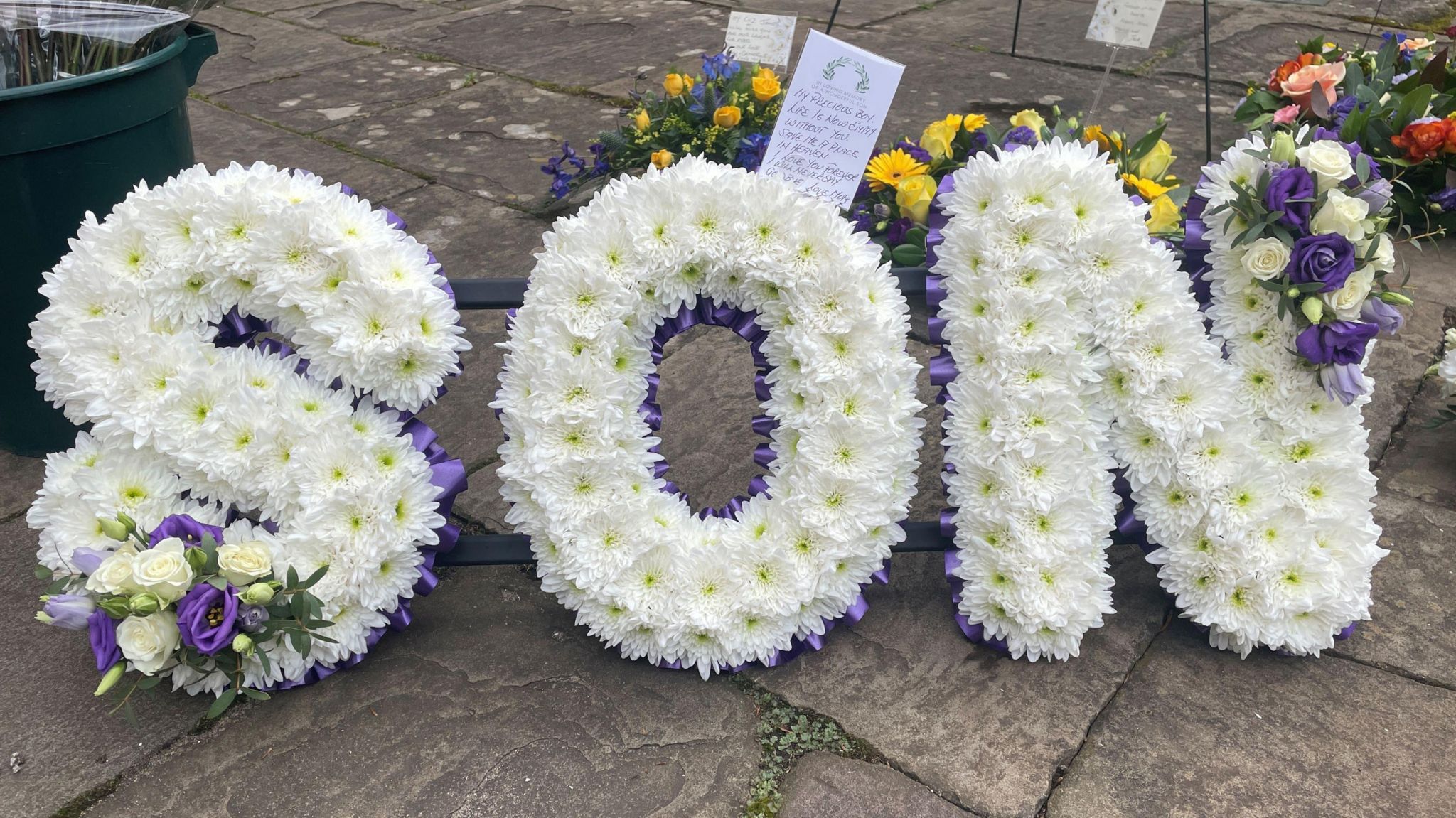 A flower arrangement saying 'son'