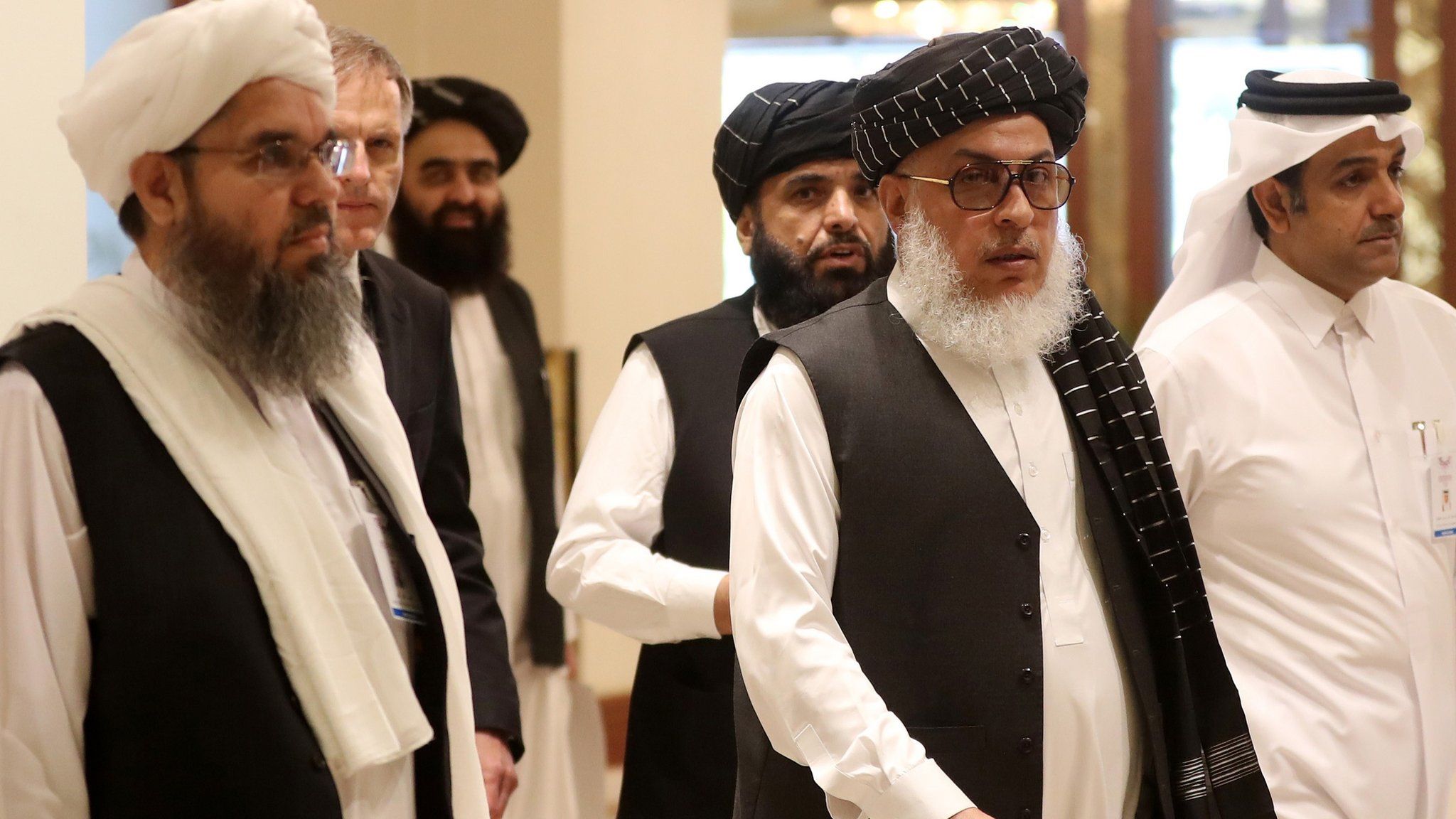 The Taliban"s former envoy to Saudi Arabia Shahabuddin Delawar (L) arrives with Taliban Qatar spokesman Suhhail Shaheen (C, behind) and Taliban negotiator Abbas Stanikzai (C, front) to attend the Intra Afghan Dialogue talks in the Qatari capital Doha on July 7, 2019.