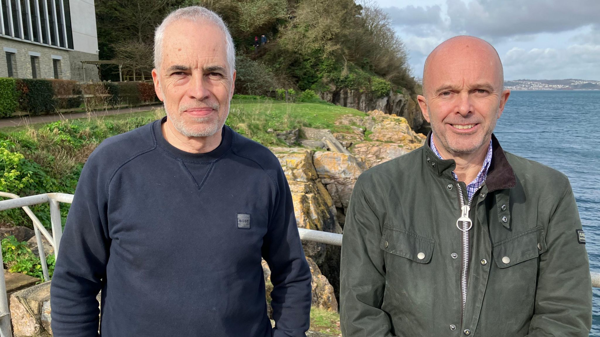 Prof Simon Jackson and Dr Keiron Fraser standing outside a laboratory on the coast in Devon