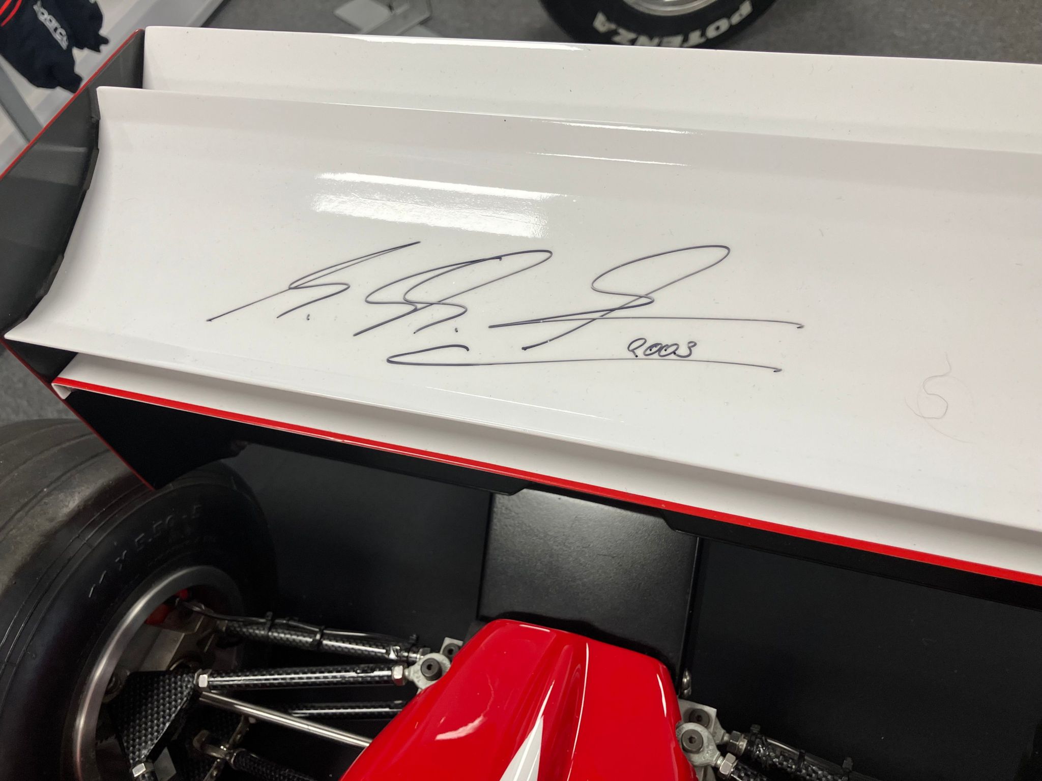 A closeup of the rear spoiler featuring Michael Schumacher's signature 