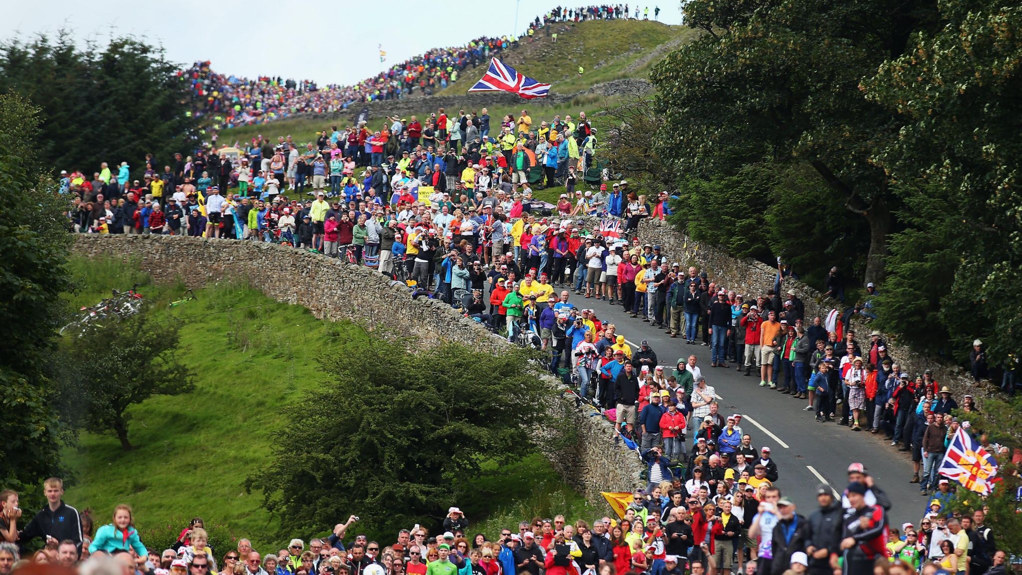 Spectators line the road side during the first stage of the 2014 Tour de France, a 190km stage between Leeds and Harrogate, on July 5, 2014 in Harrogate, England. 