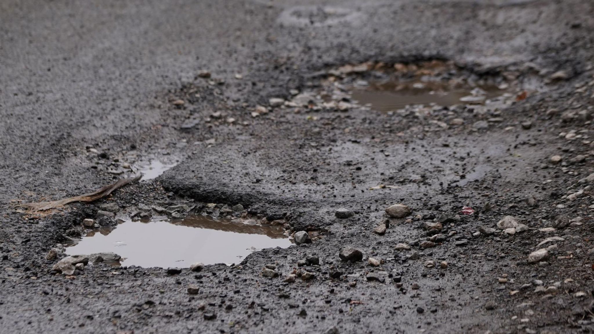 Potholes filled with water in a road