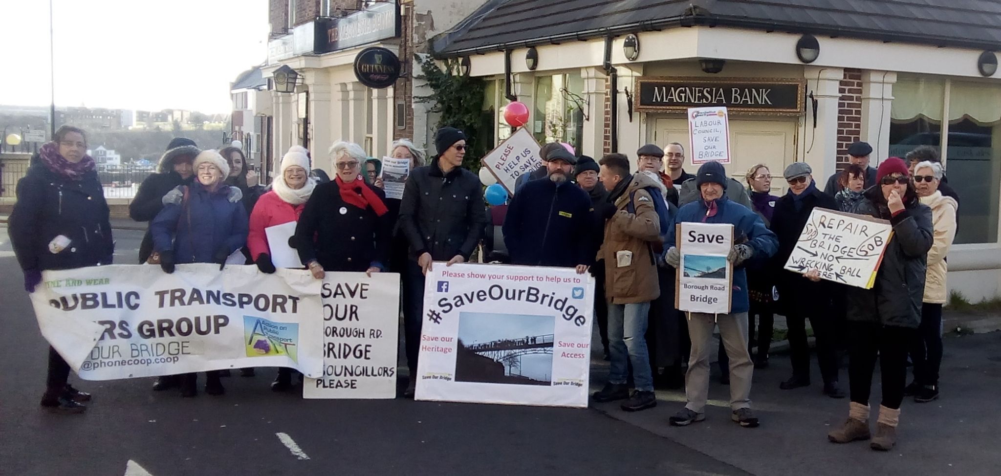 Members of the Save Our Bridge group holding banners and signs