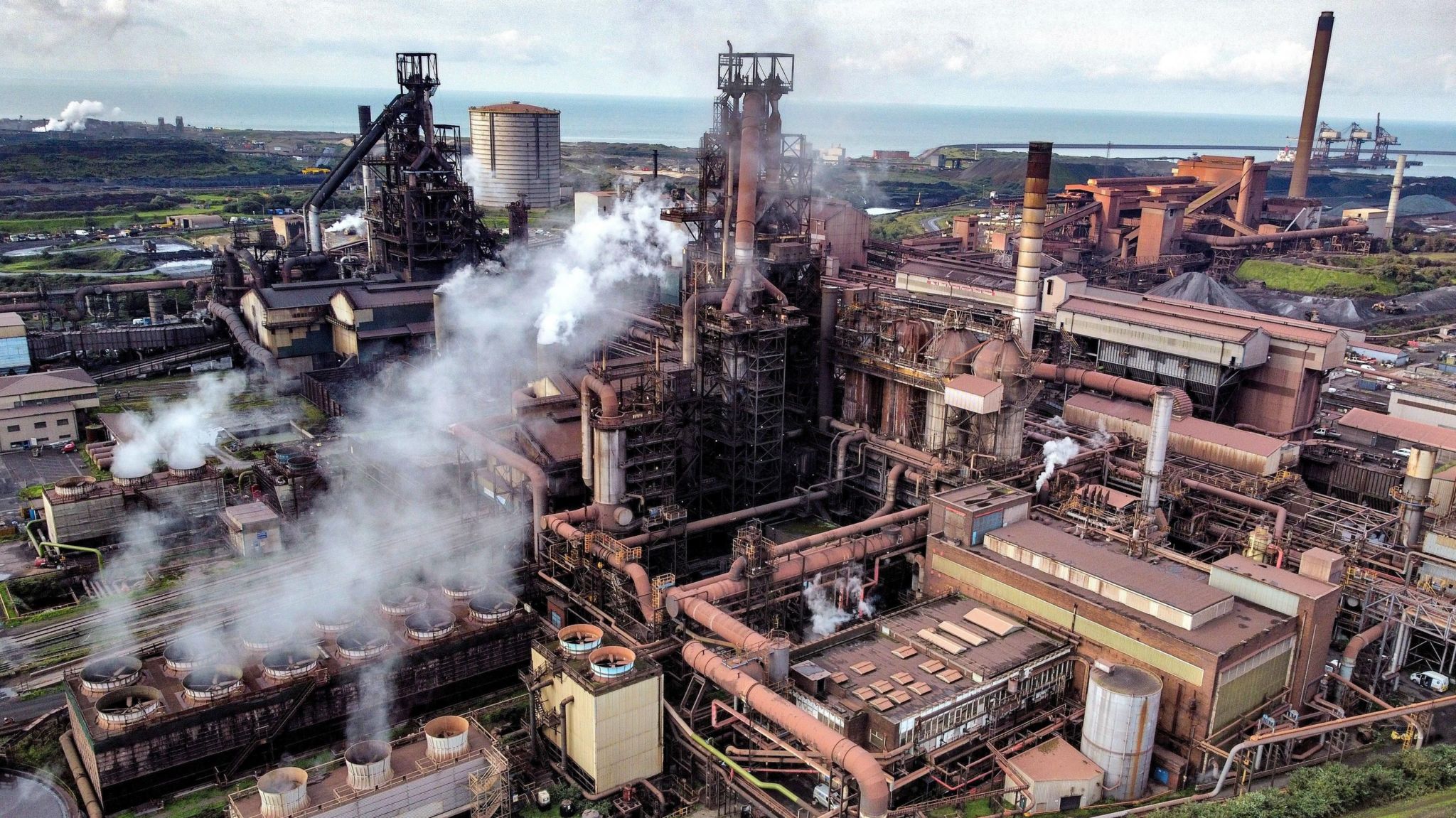 The Port Talbot steelworks with smoke coming out of the furnaces