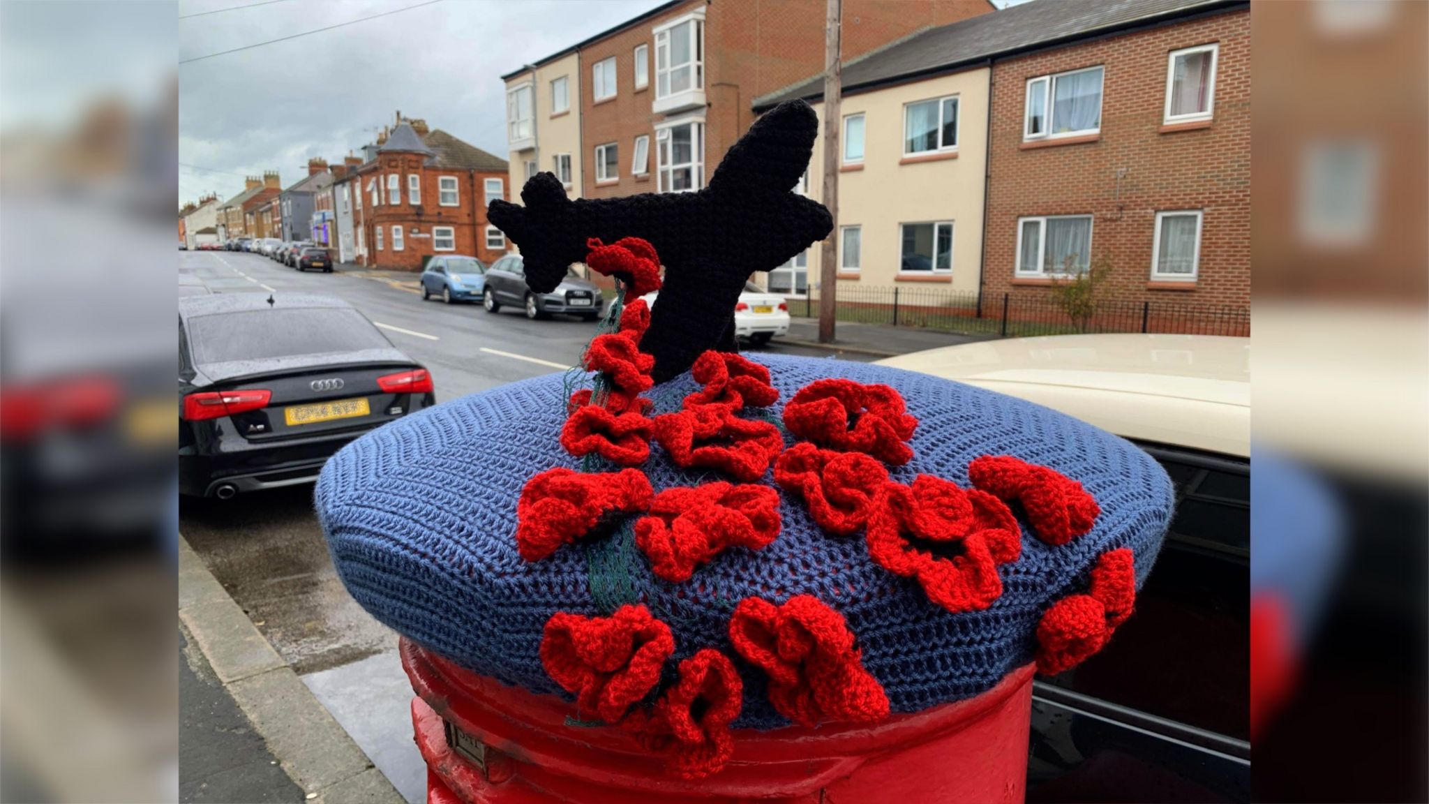 A postbox topper in Withernsea shows a plane releasing poppies into the sea