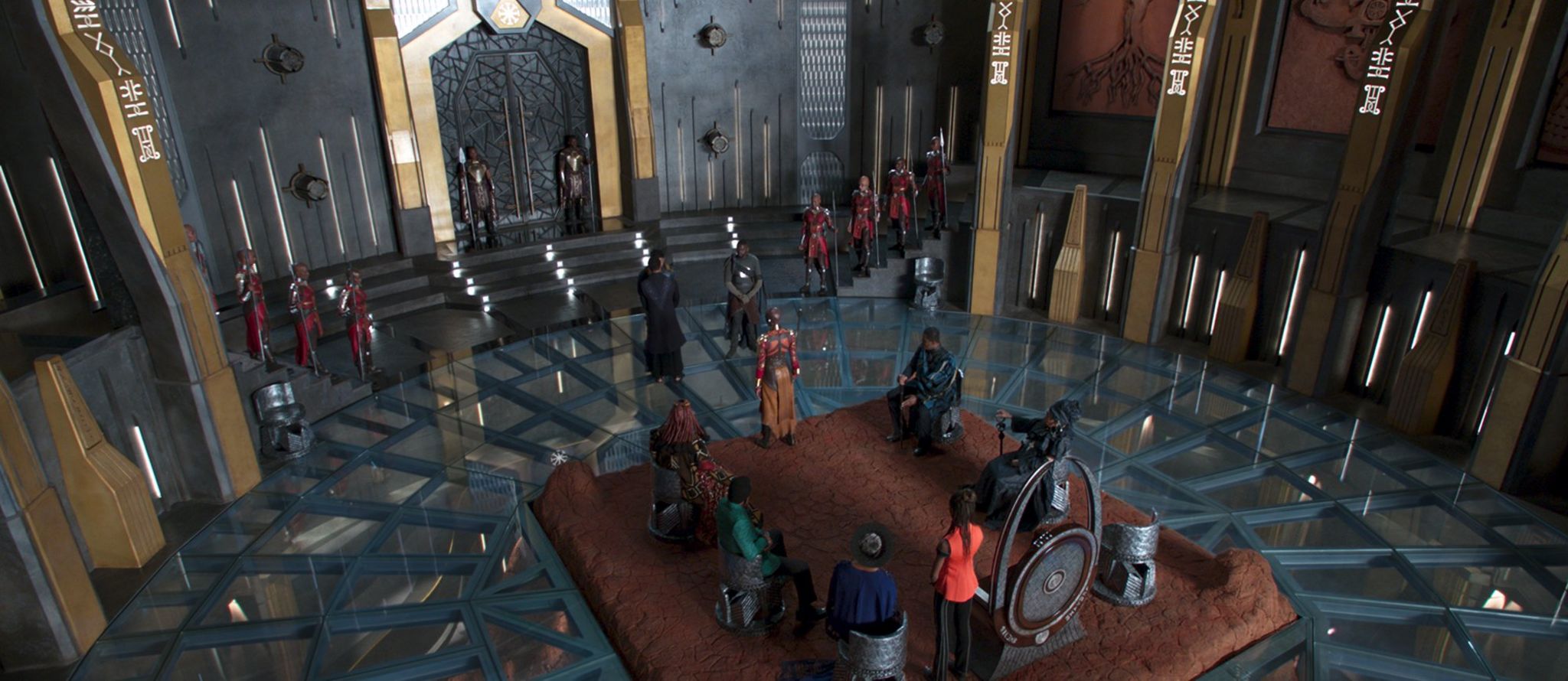 Movie still of Wakanda opulent futuristic courtyard with female warriors guarding doors.