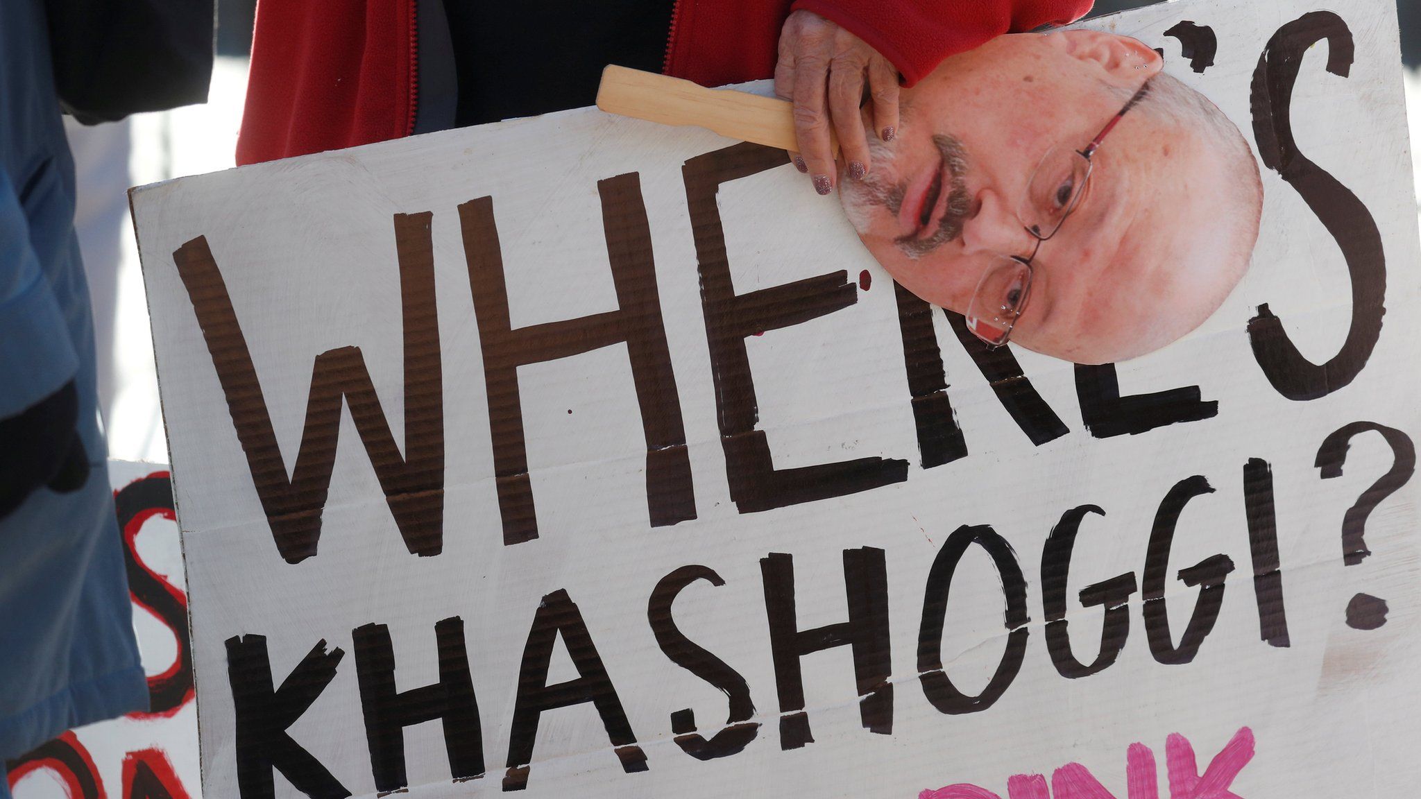 An activist holds a sign and image of missing Saudi journalist Jamal Khashoggi during a demonstration outside the White House in Washington, October 19, 2018