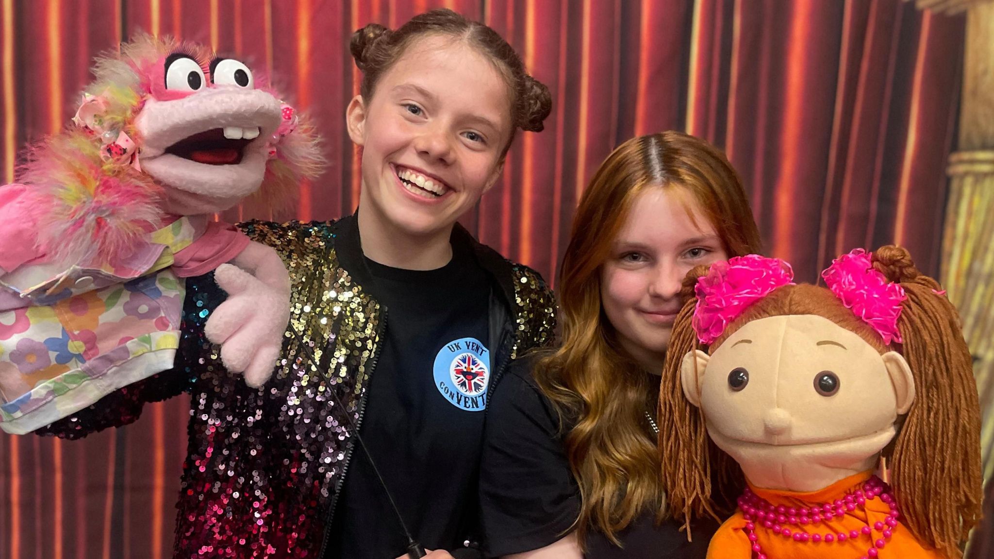 Two teenager girls smiling with their puppets