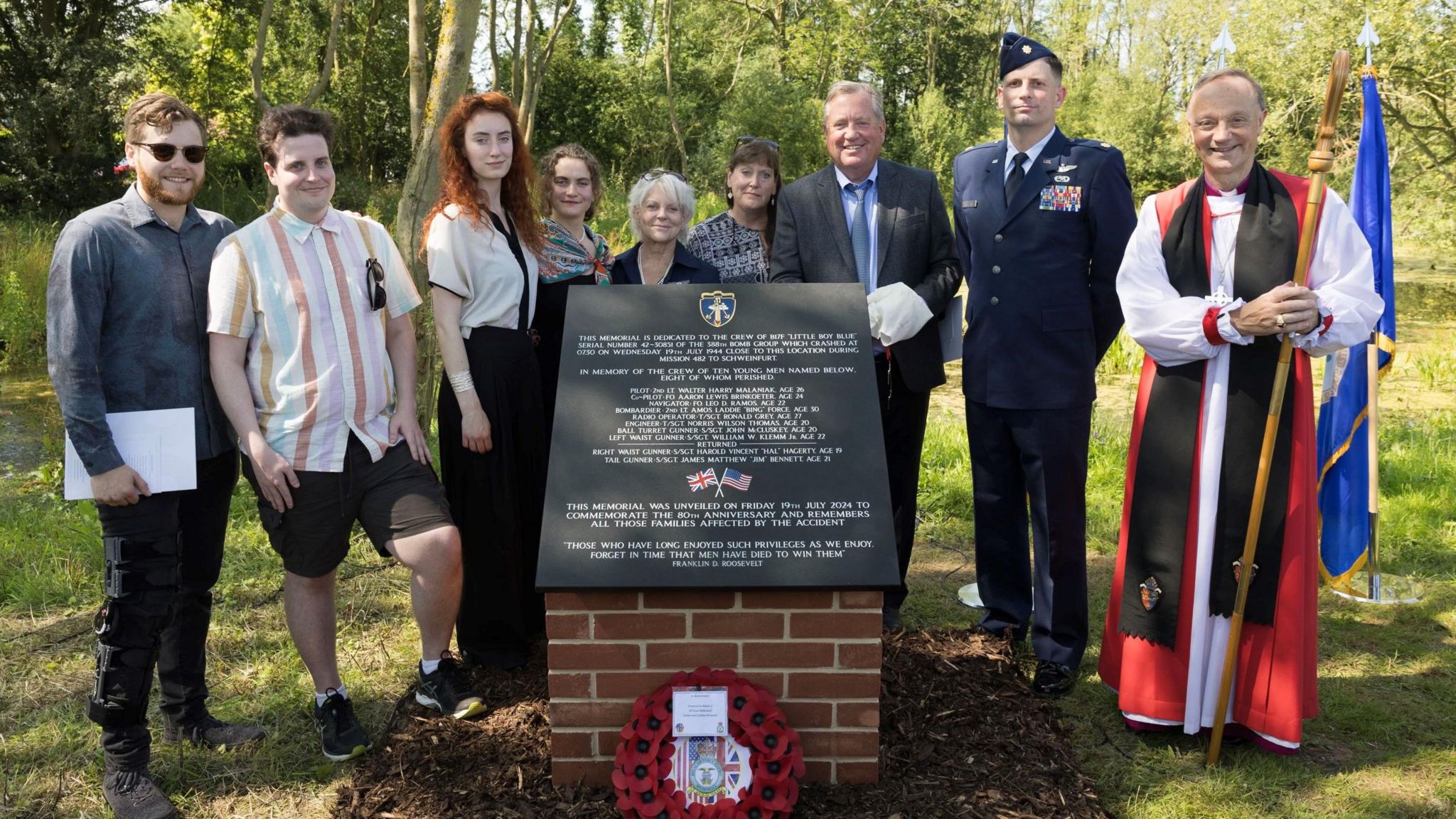 The Rt Revd Dr Mike Harrison Suffragan Bishop of Dunwich, right, pictured at the memorial  with, Patrick V Hagerty, 3rd from right, son of Harold Vincent 'Hal' Hagerty who survived the crash, with other descendants along with Major William Mullins of the USAF, 2nd from right