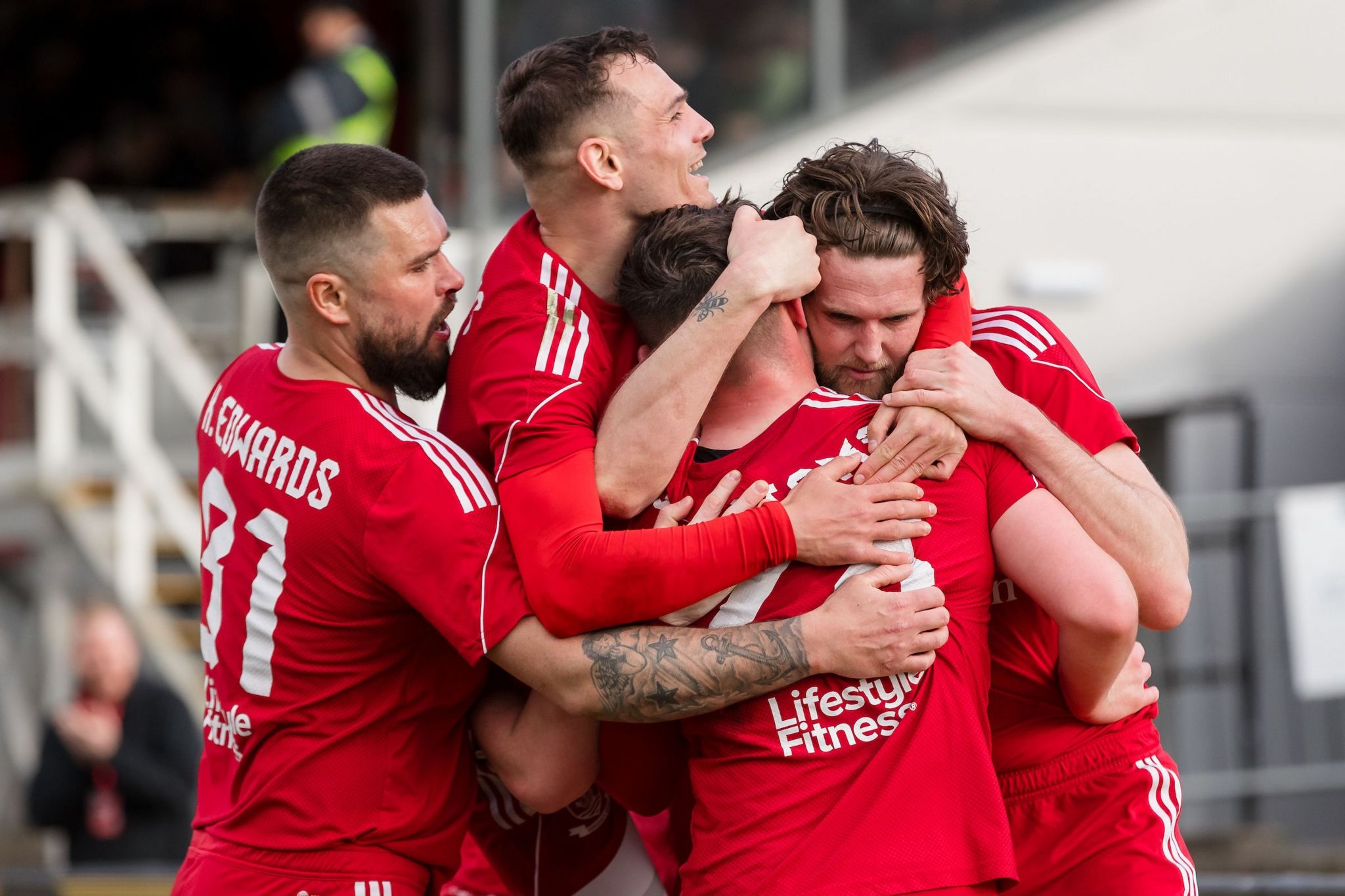 Josh Williams is mobbed by Connah's Quay Nomads team-mates after scoring the winner against New Saints