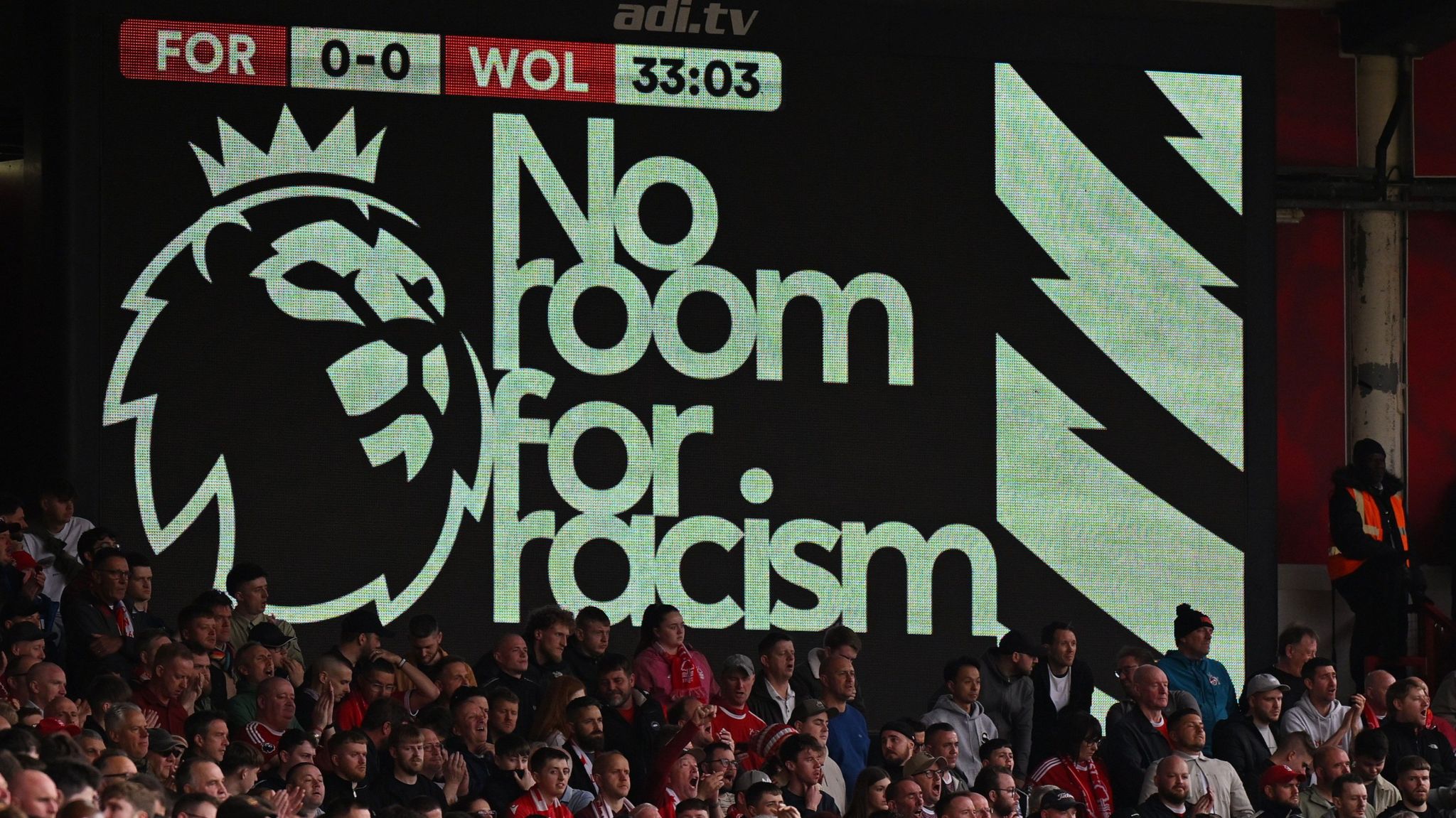 A screen shows the message 'no room for racism'