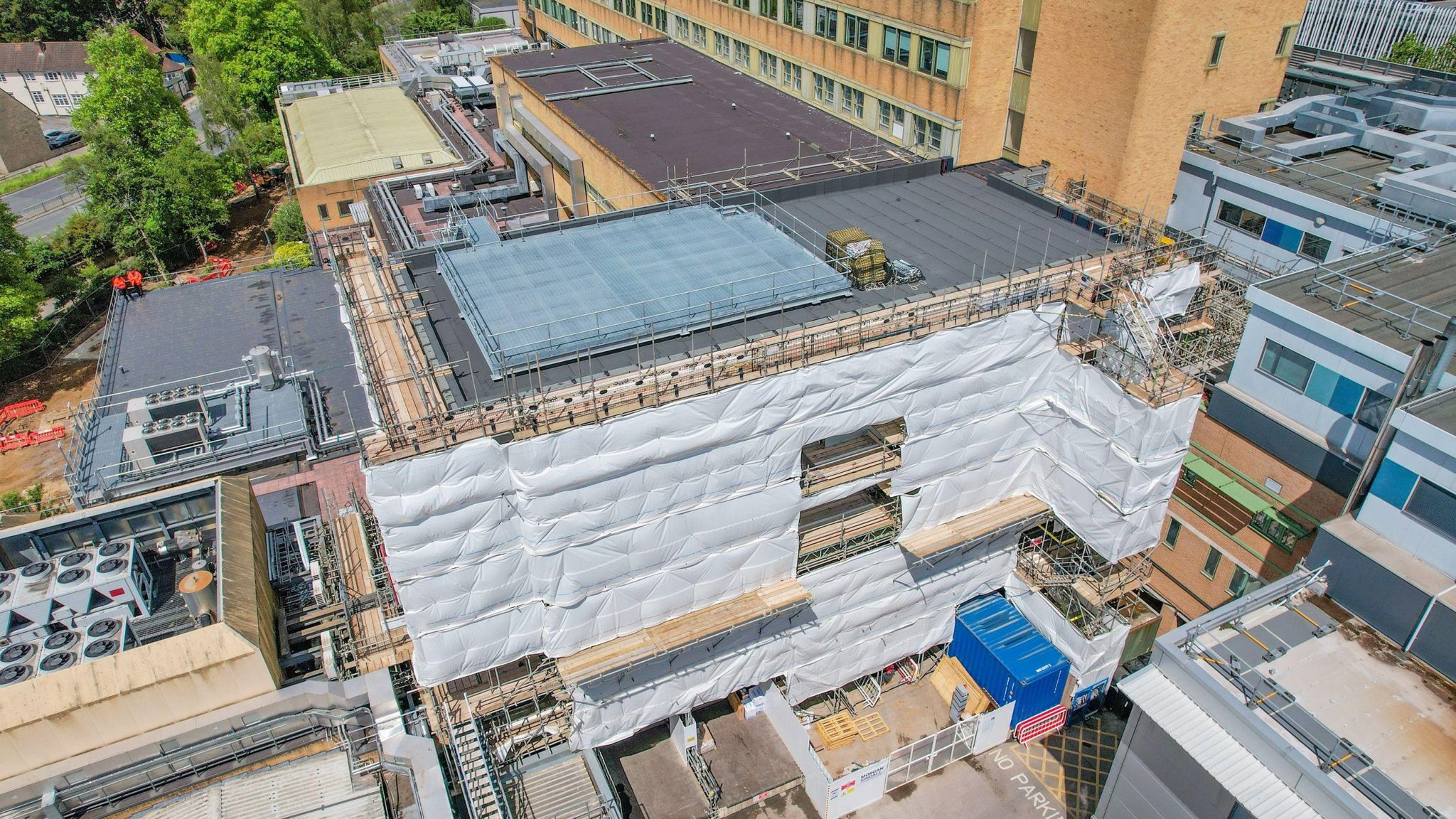 An aerial shot of a hospital building with scaffolding around it