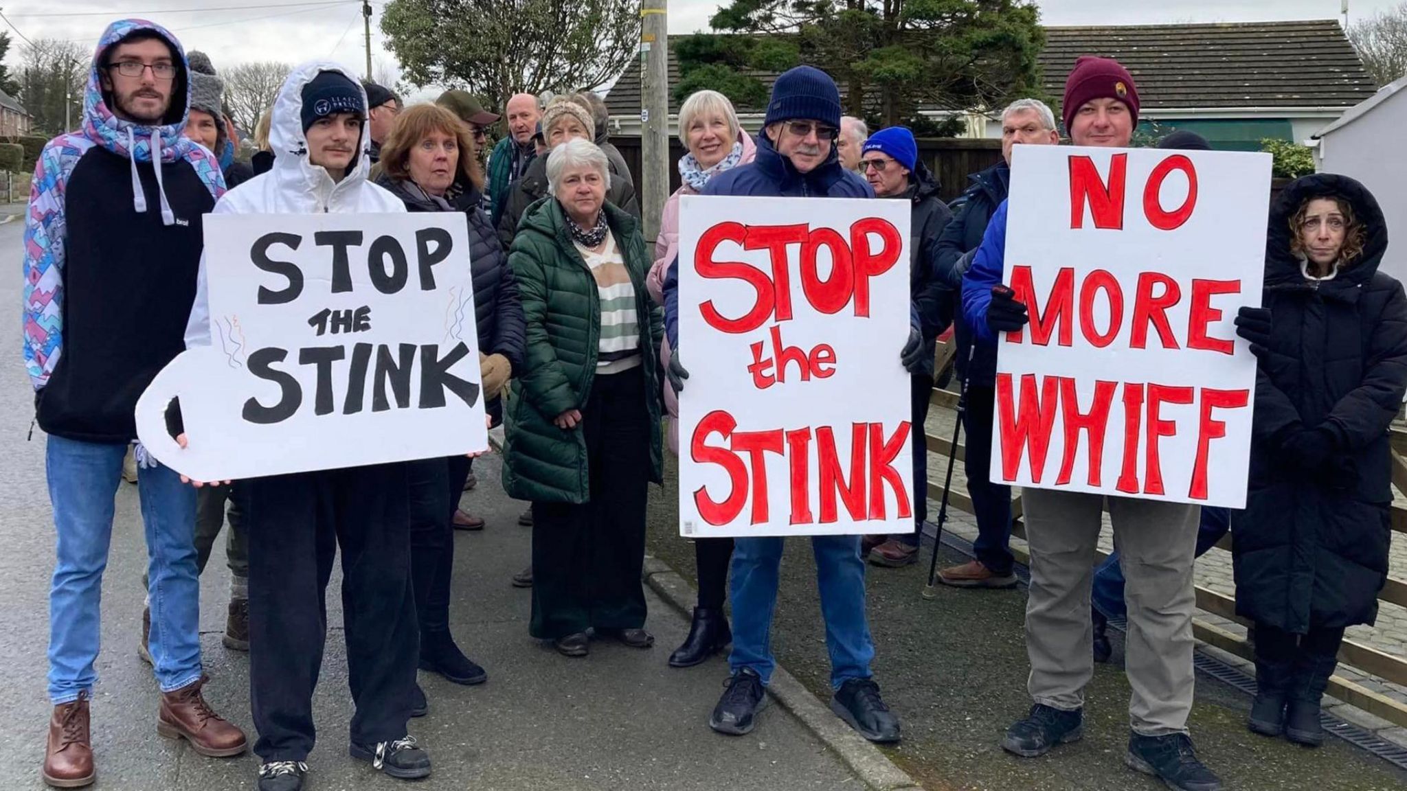Protestors stood on the road with signs saying 'stop the stink'