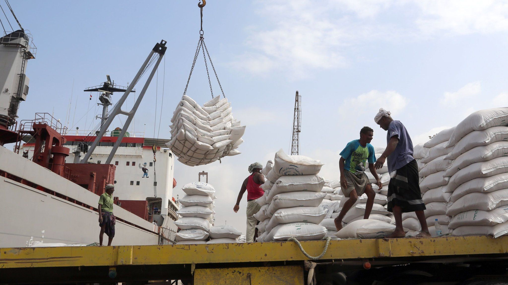 File photo showing workers unload food aid provided by Unicef from a cargo ship at the Red Sea port of Hudaydah (27 January 2018)