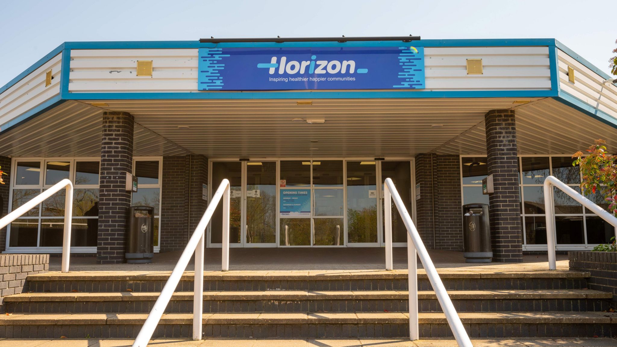 Horizon Leisure Centre, outside the building taken from the bottom of the steps shows big blue sign with the words Horizon