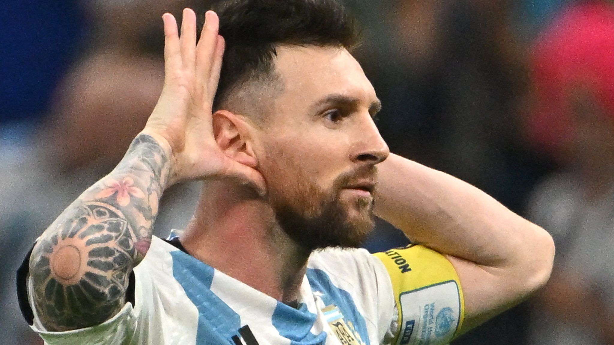 Lionel Messi cups his ears to the Netherlands bench