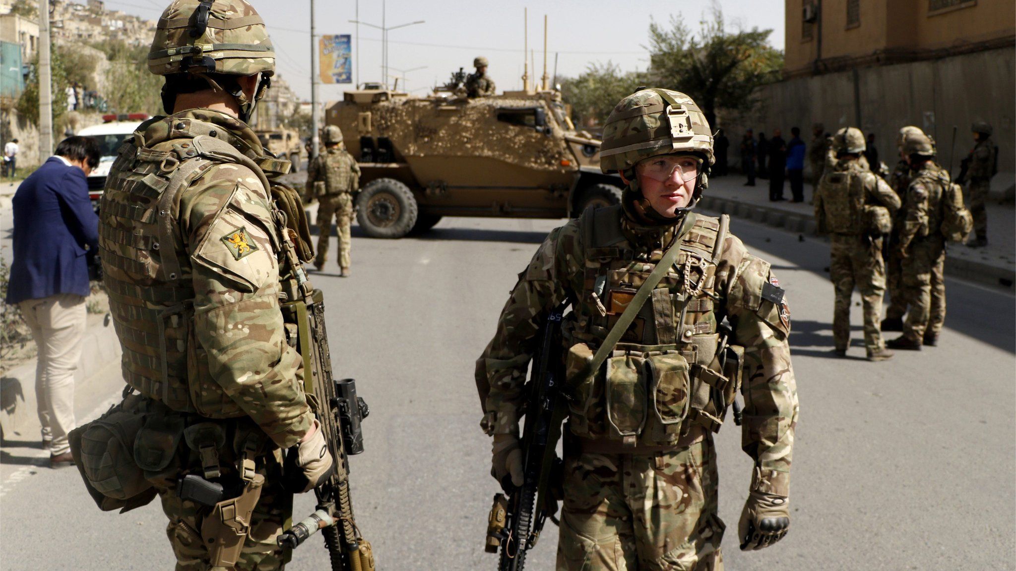 NATO soldiers inspect the scene of a suicide bomb attack in Kabul, Afghanistan, 11 October 2015