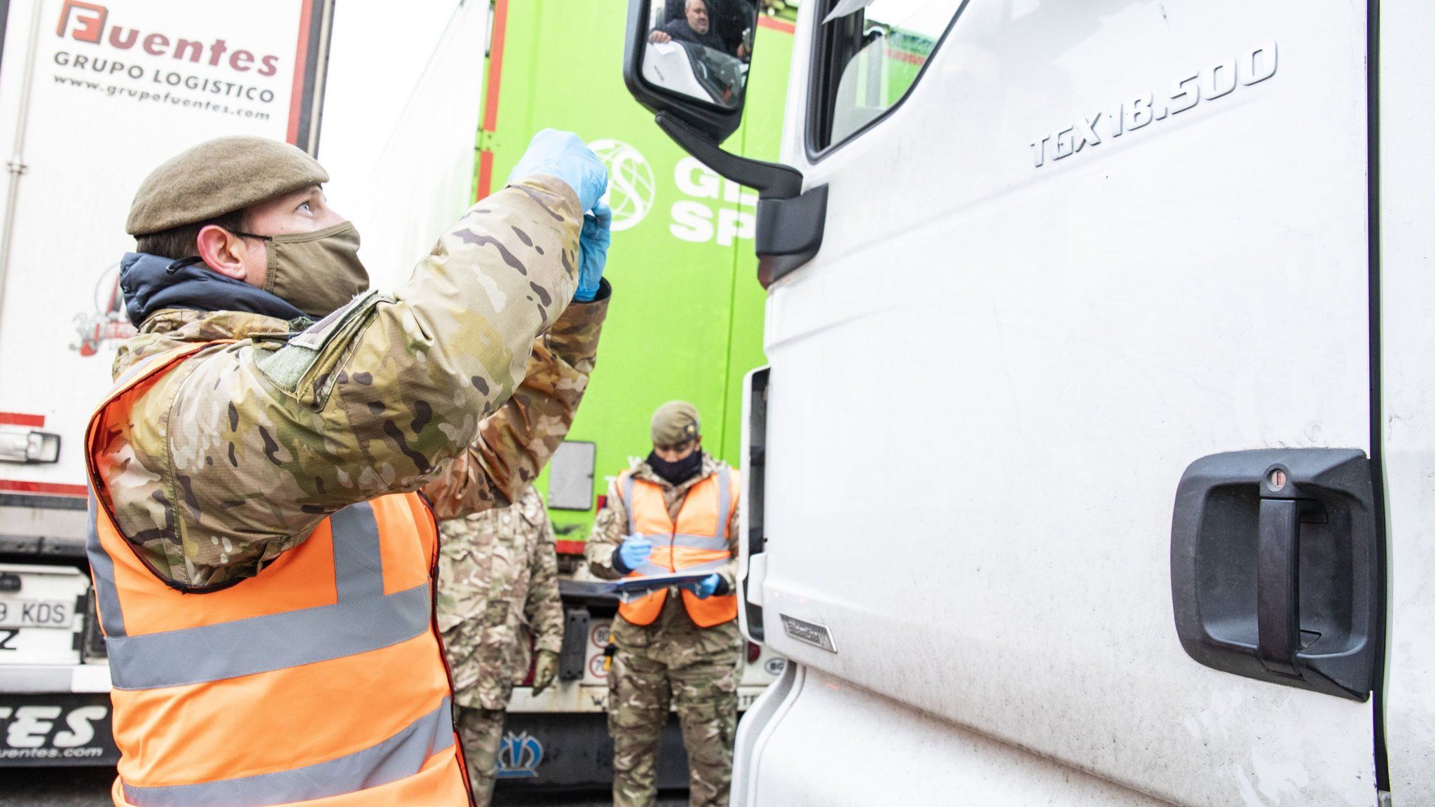British Army soldier delivering a Covid-19 test to a lorry driver at Manston airfield in Kent on 25 December