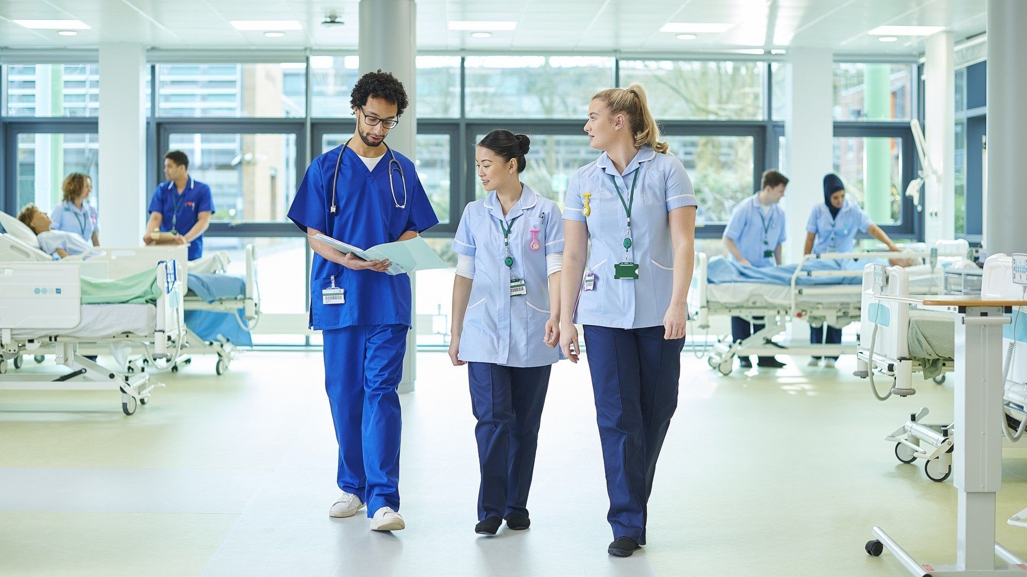 Three nurses locomotion  on  a ward