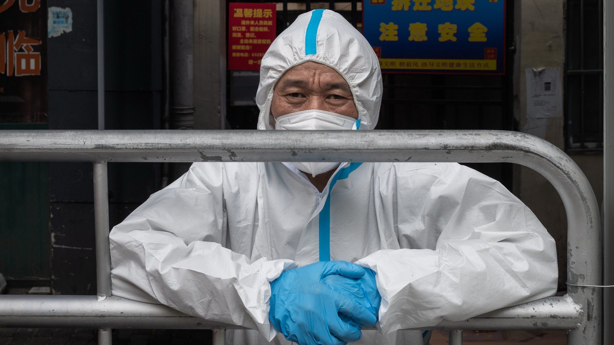 A worker in PPE guards at a position set up in the great Covid-19 lockdown in Shanghai, China.