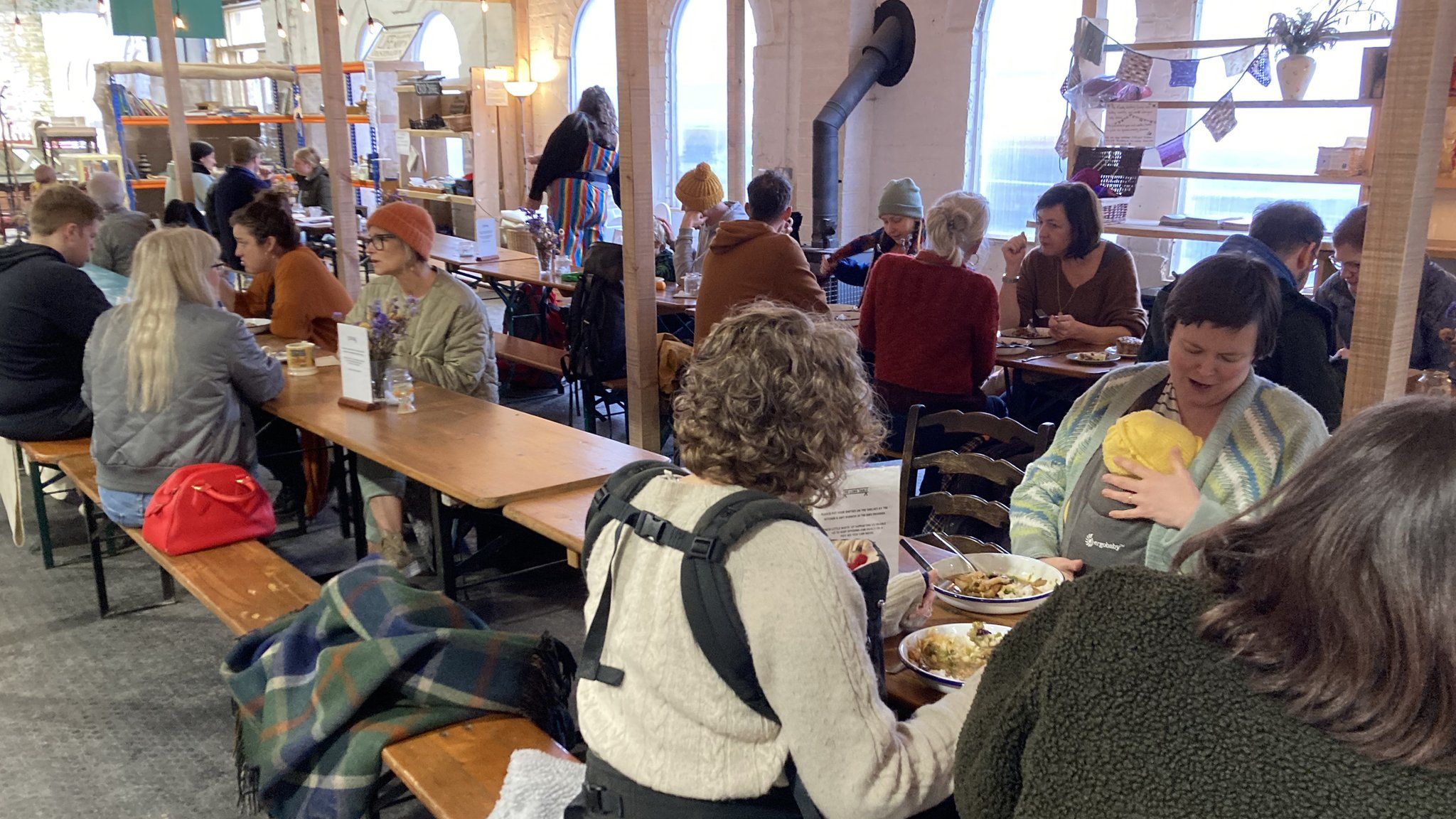 People sat around long tables eating