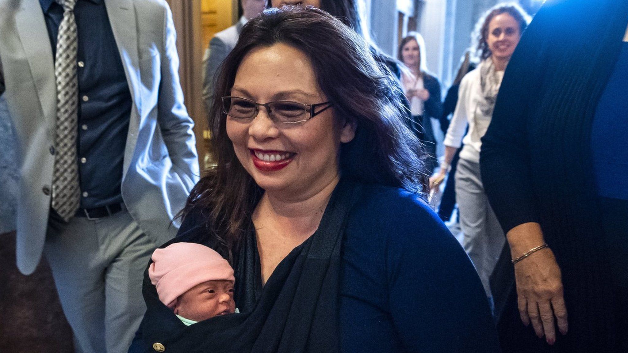 Democratic Senator from Illinois Tammy Duckworth carries her 10-day old daughter Maile Pearl Bowlsbey onto the Senate floor