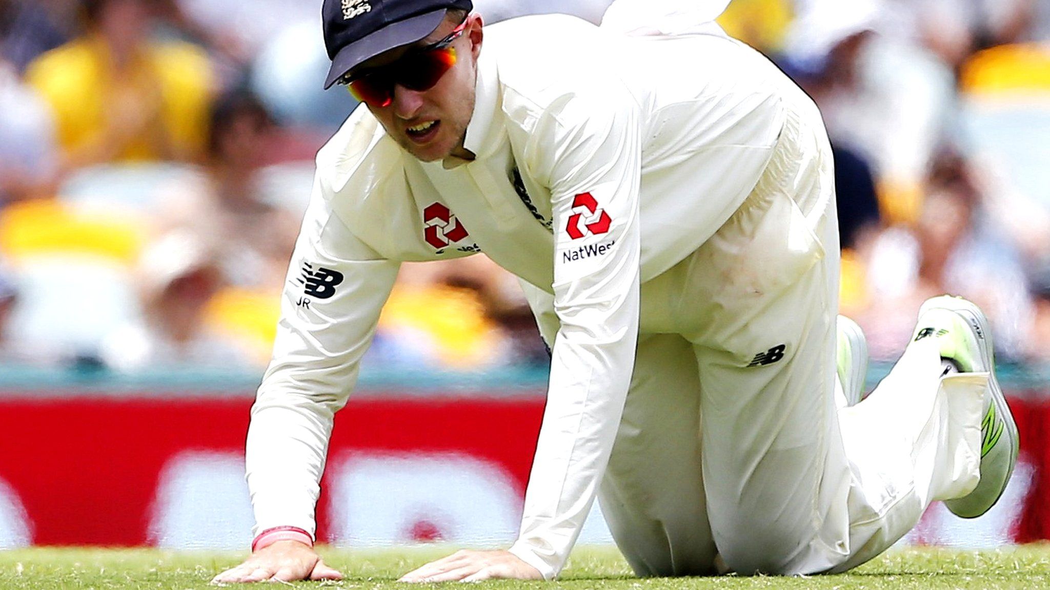 England captain Joe Root kneels on the outfield