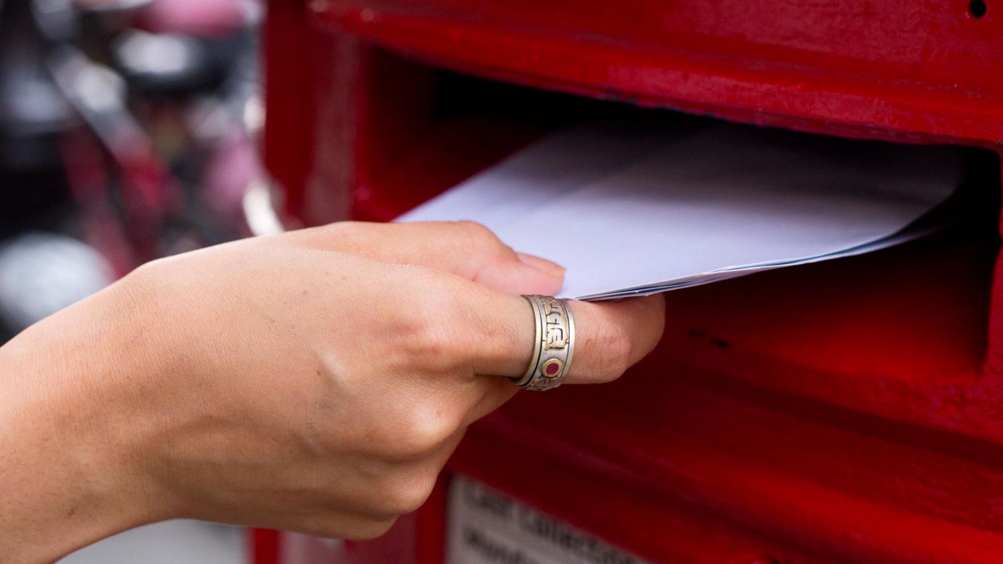Envelopes being put into a postbox