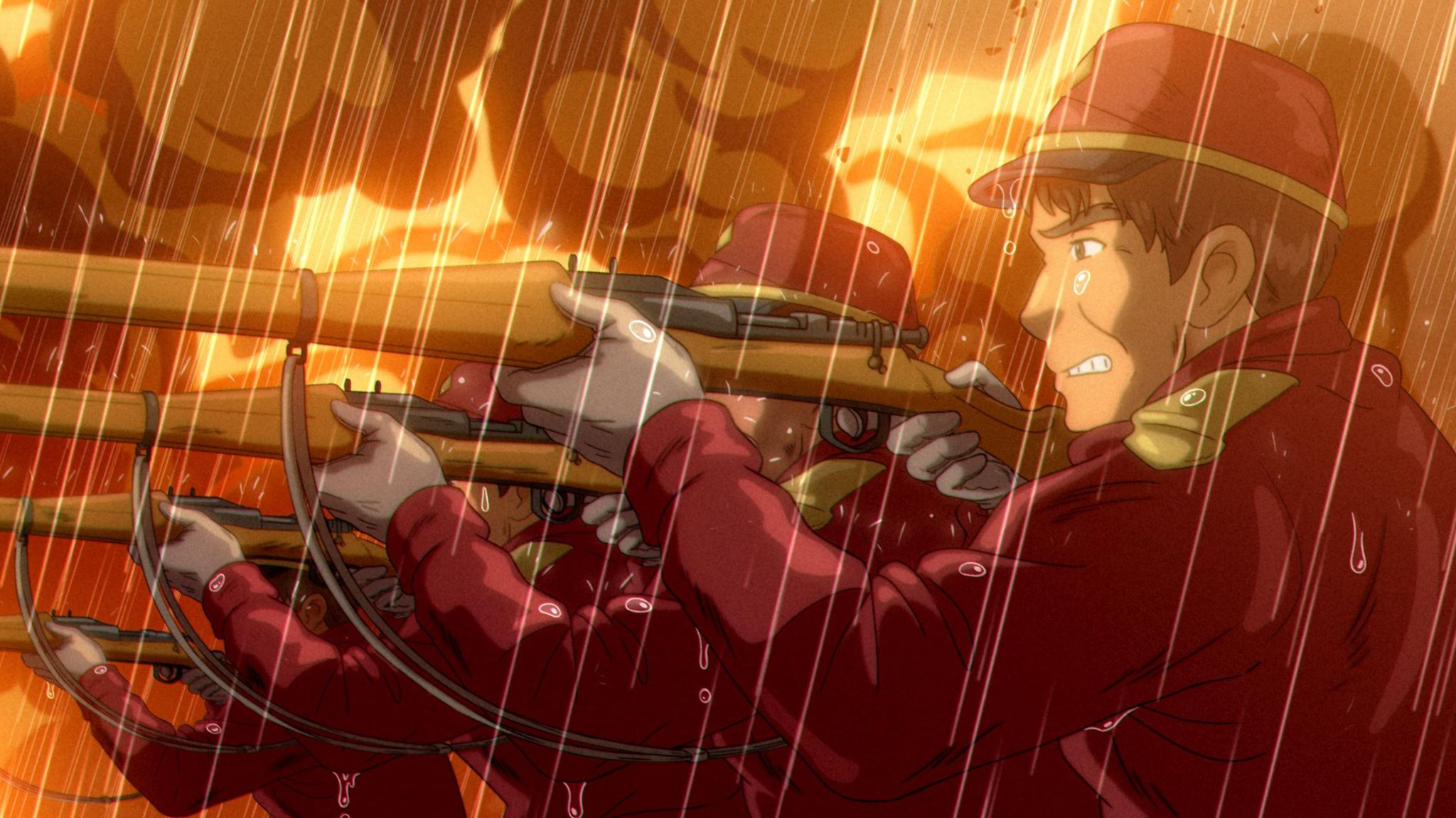 A still from The Glassworker shows a line of soldiers in red uniforms pointing rifles at an unseen target. Rain pours from the sky above and a fire emanating thick black smoke rages in the background.