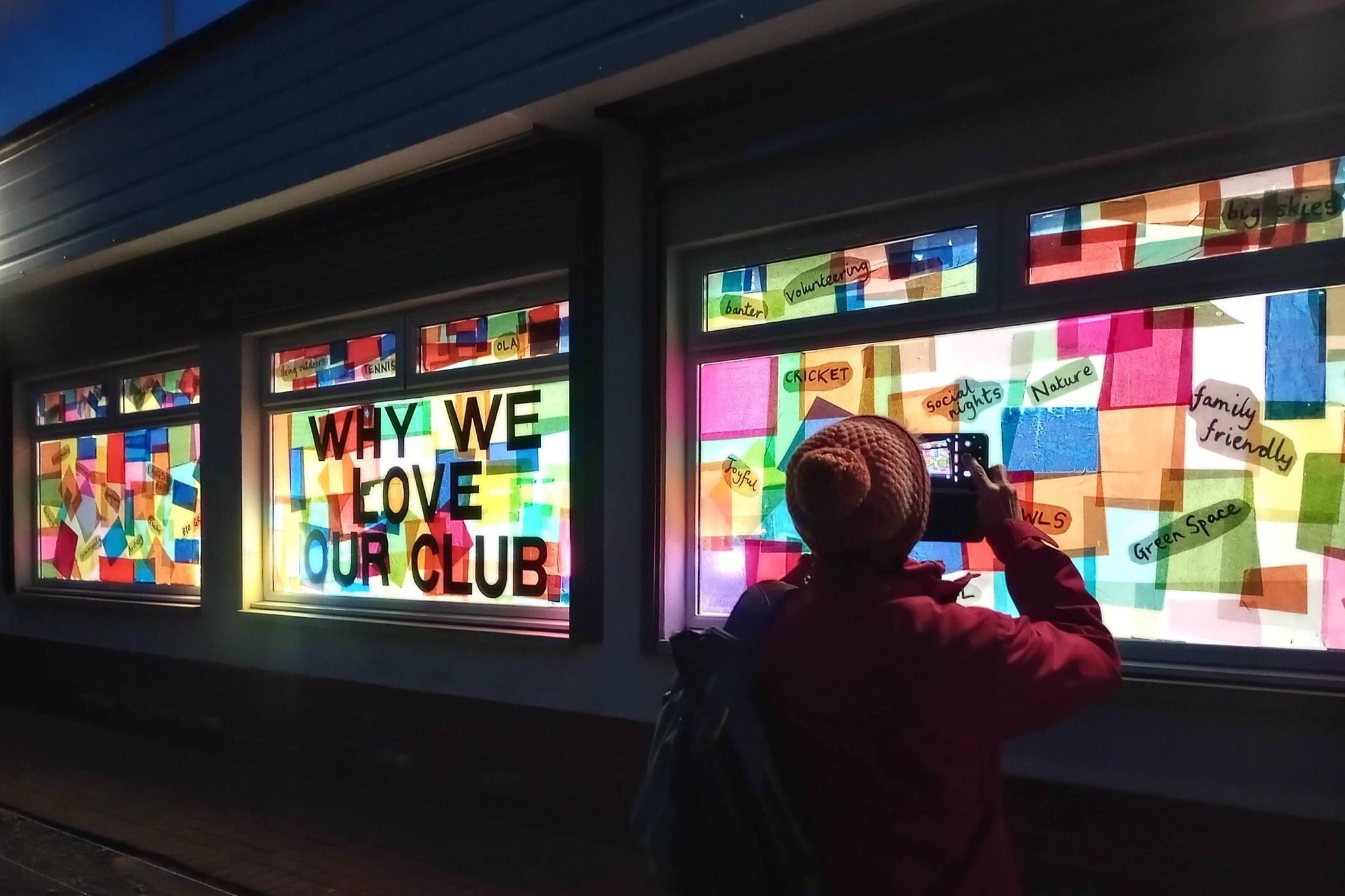 Window reads 'why we love our club' with responses on either side