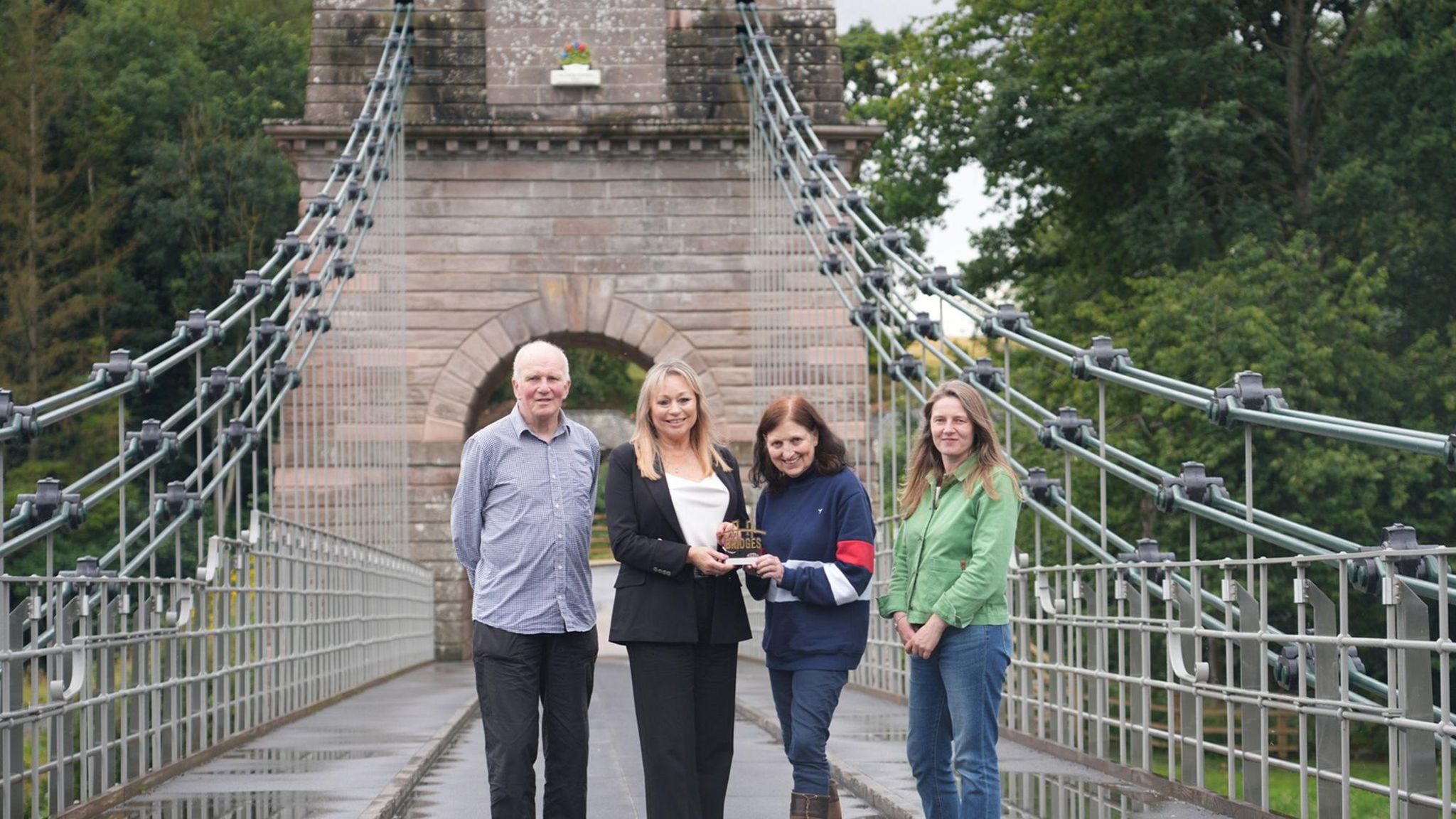 Customer Relationship Manager Diane Rowe, second left, presents the award to Friends of Union Chain Bridge members, from left, Founding Trustee and Honorary Secretary Edward Cawthorn; Chair Martha Andrews; and founding member Heather Thompson