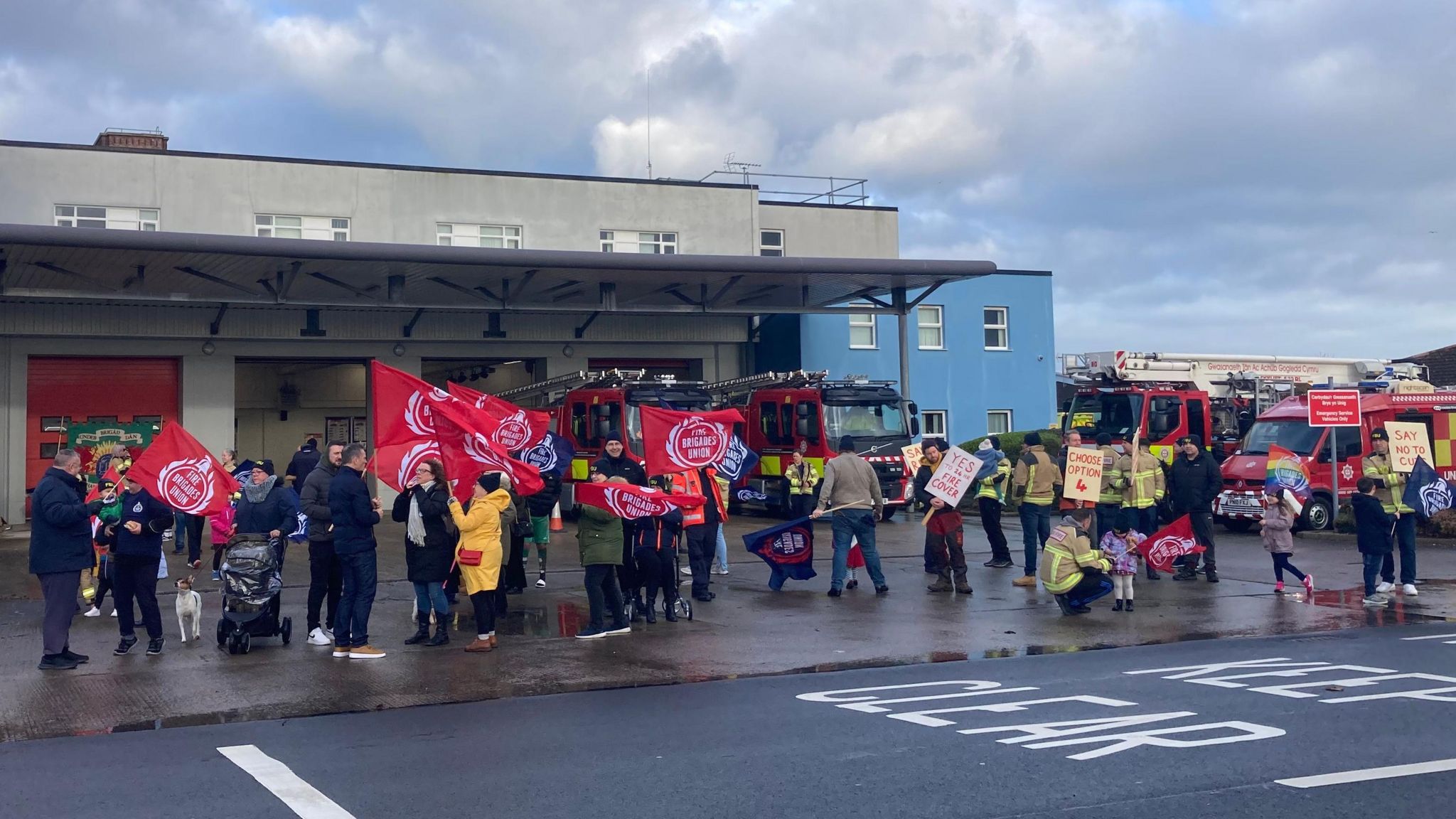 Placard-waving protesters outside Rhyl Fire Station