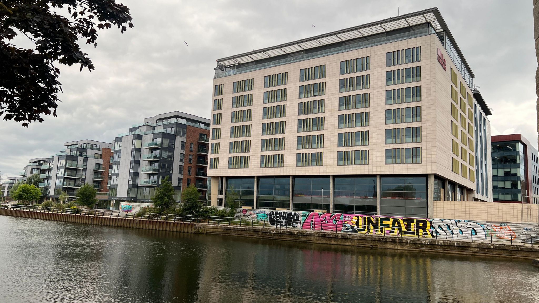 View of the Hilton Garden Inn building from the river