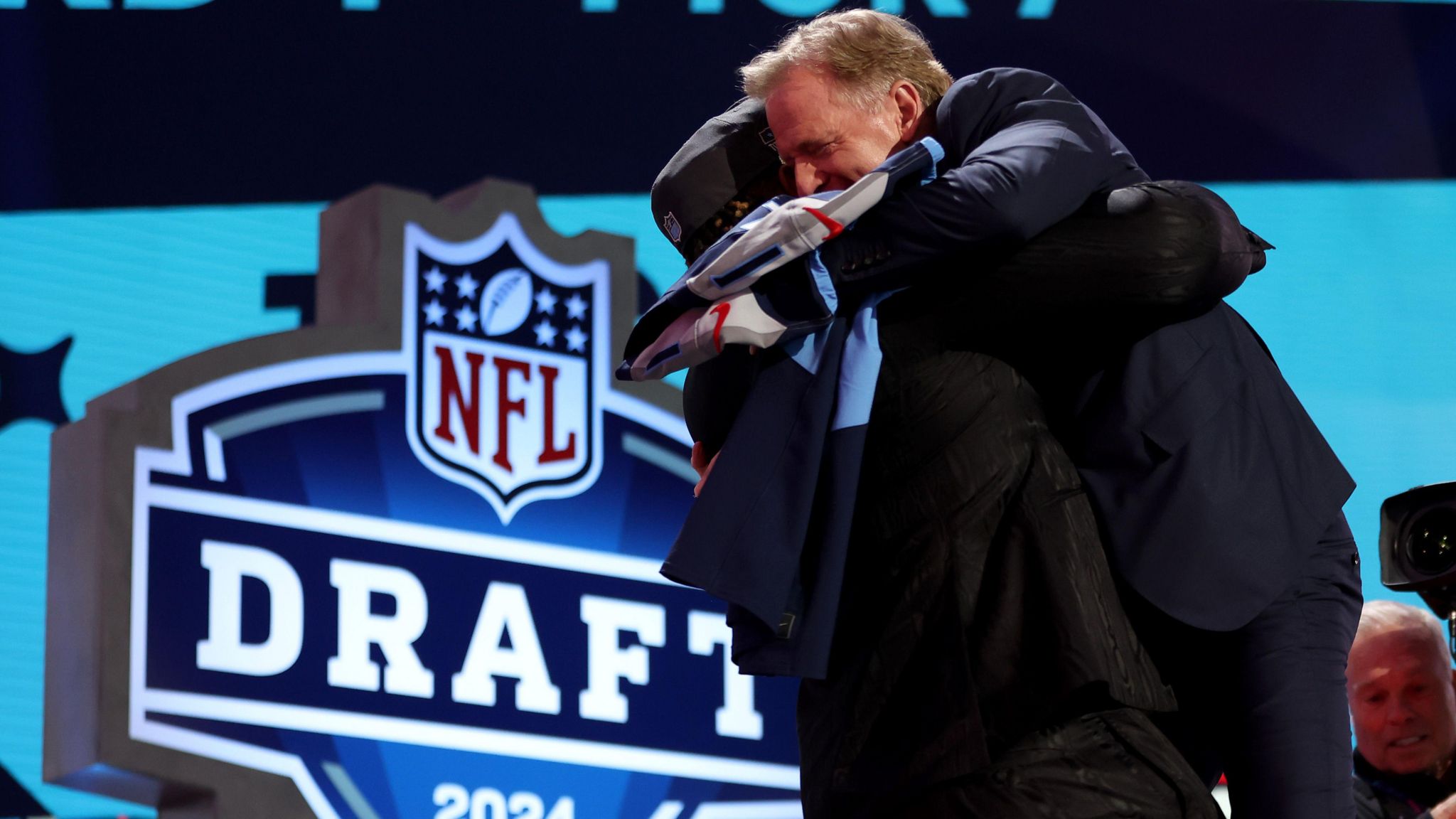 Roger Goodell given a bearhug by JC Latham