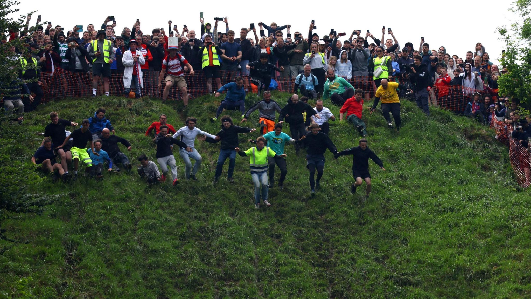 Crowds at the top of the hill as men run down