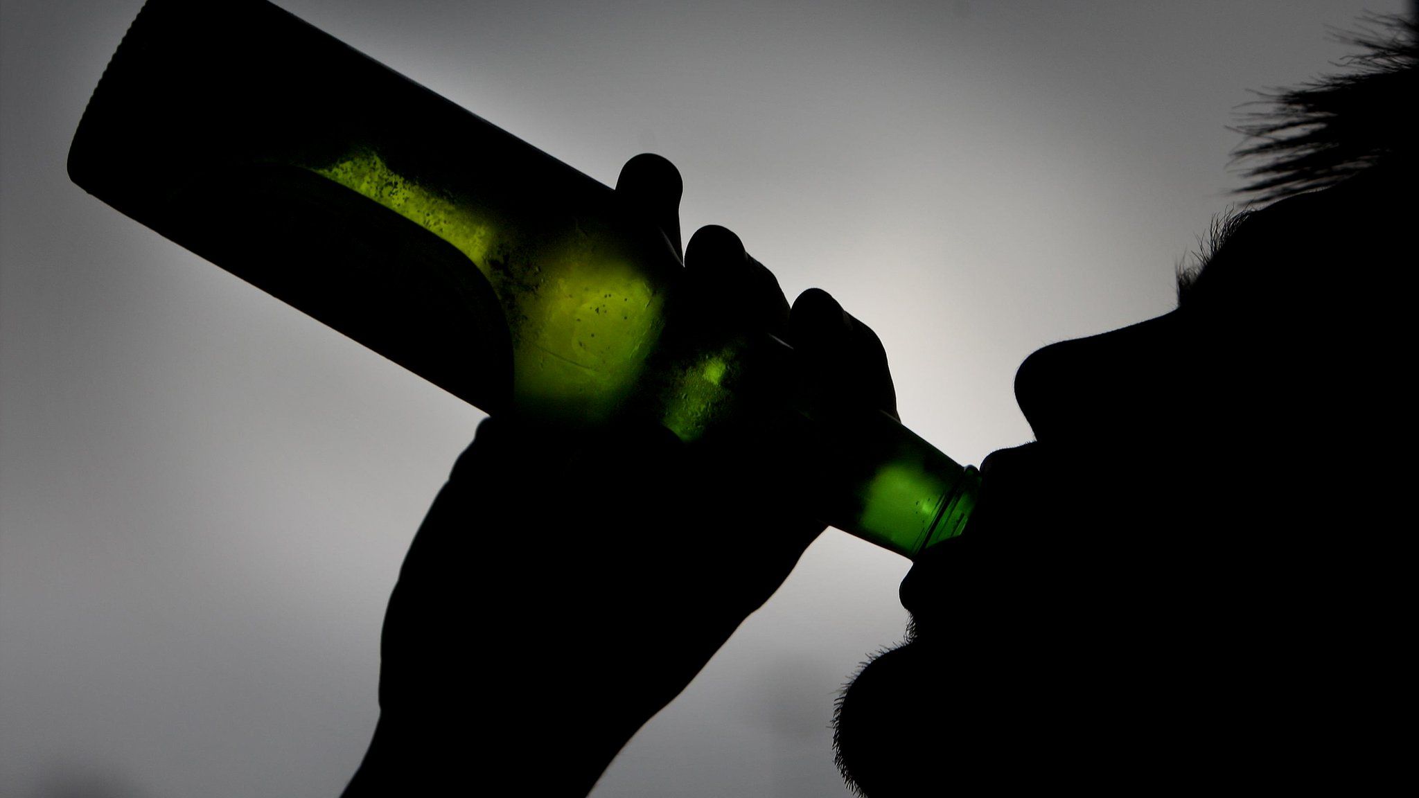 A man drinking a beer